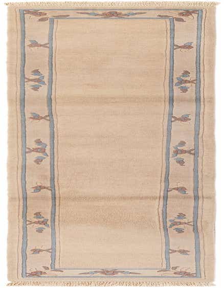 An 11 ft ivory wool runner rug with a modern oriental floral pattern in blue and muted pink, ideal for a hallway.