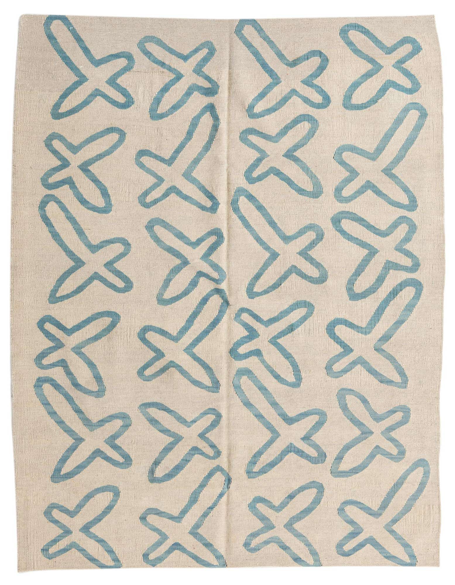 A 5'4" x 6'3" square ivory wool flatweave rug with a repeating pattern of abstract blue tribal shapes.