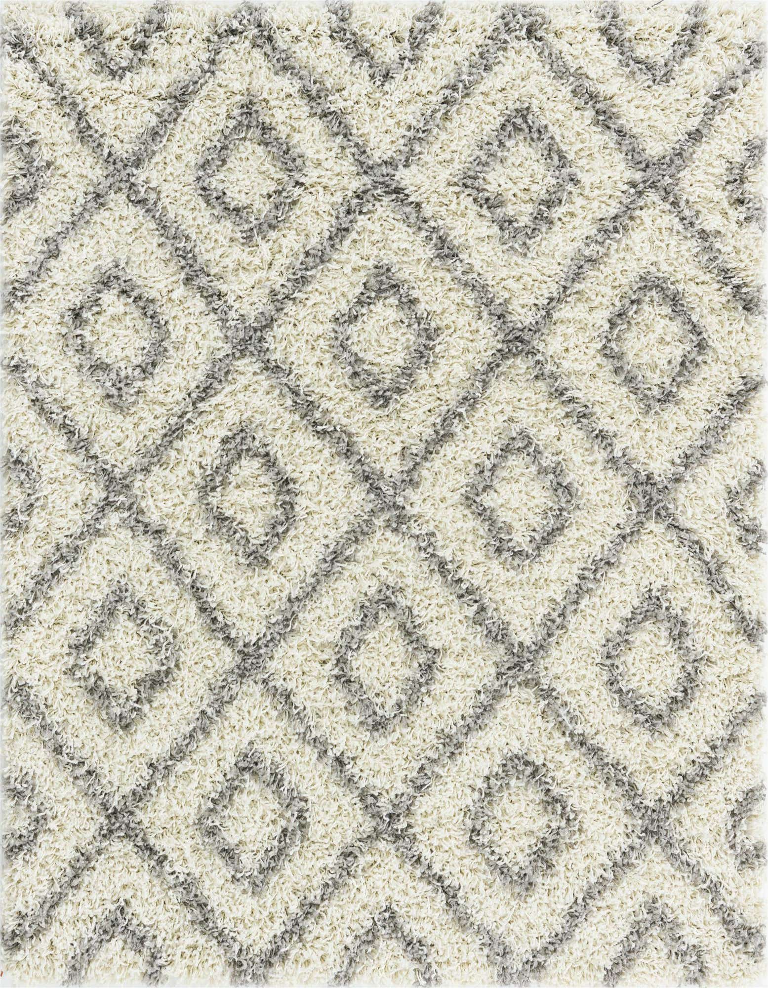 A square ivory shag rug with a modern grey abstract lattice pattern and high/low textured pile.