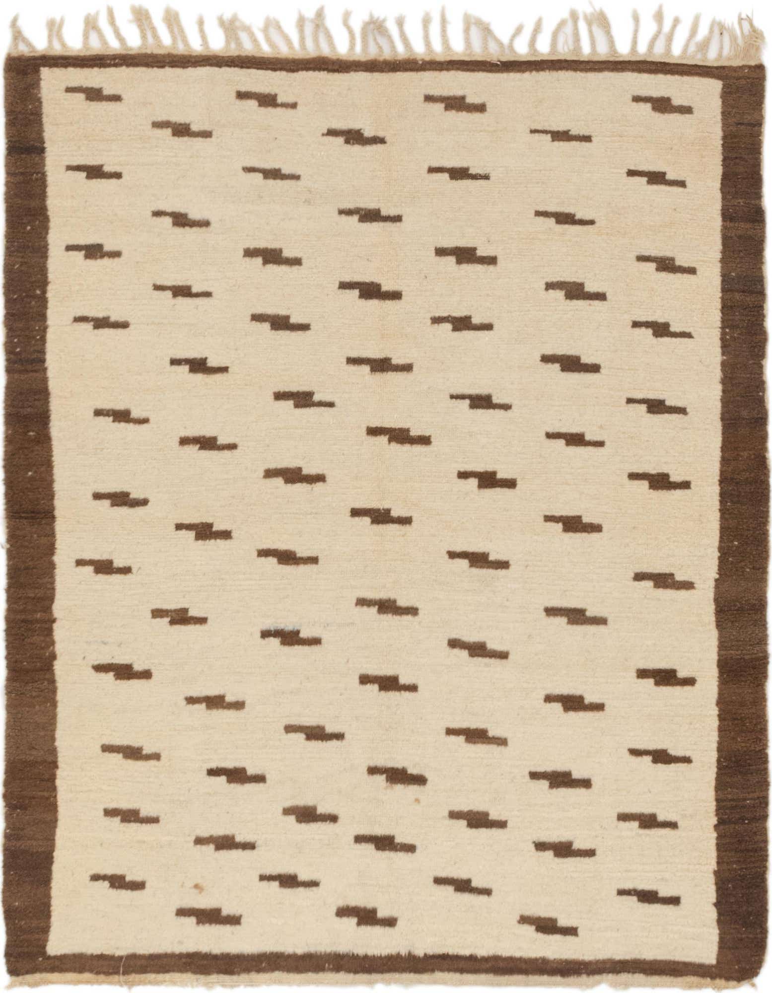 A 4'9" x 5'7" square ivory shag rug with a repeating brown tribal pattern and brown border, ideal for an indoor living space.