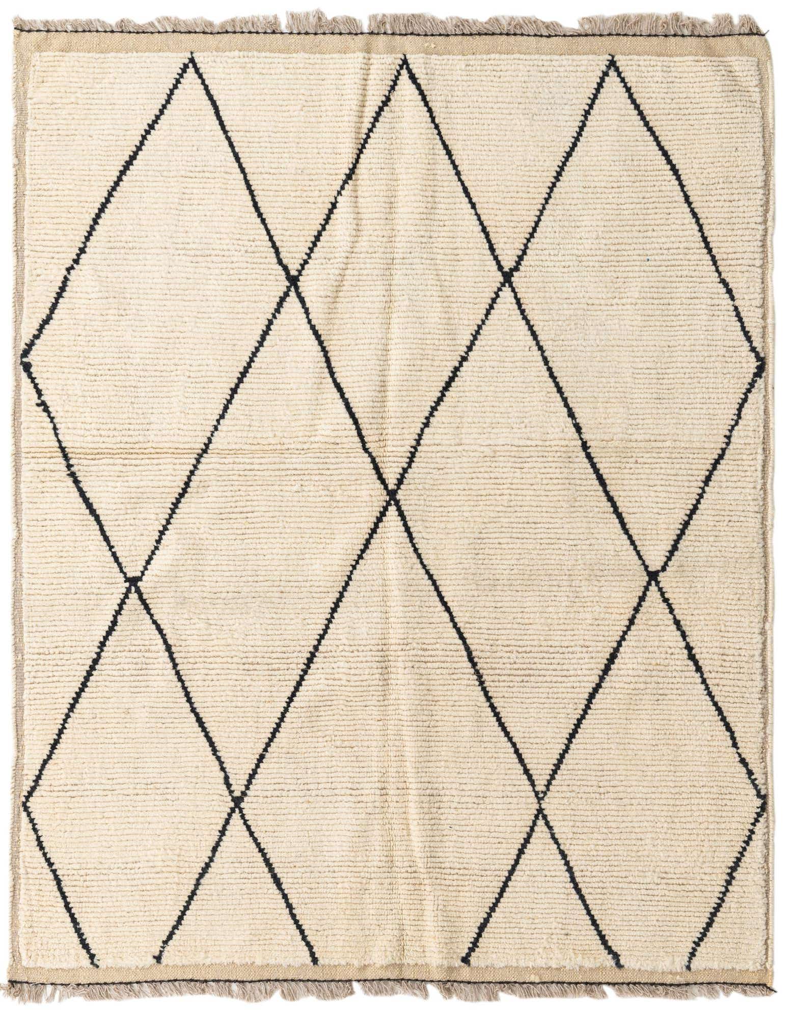 A 5' 5 x 6' 7 square ivory shag rug with a black tribal diamond pattern and fringed edges.