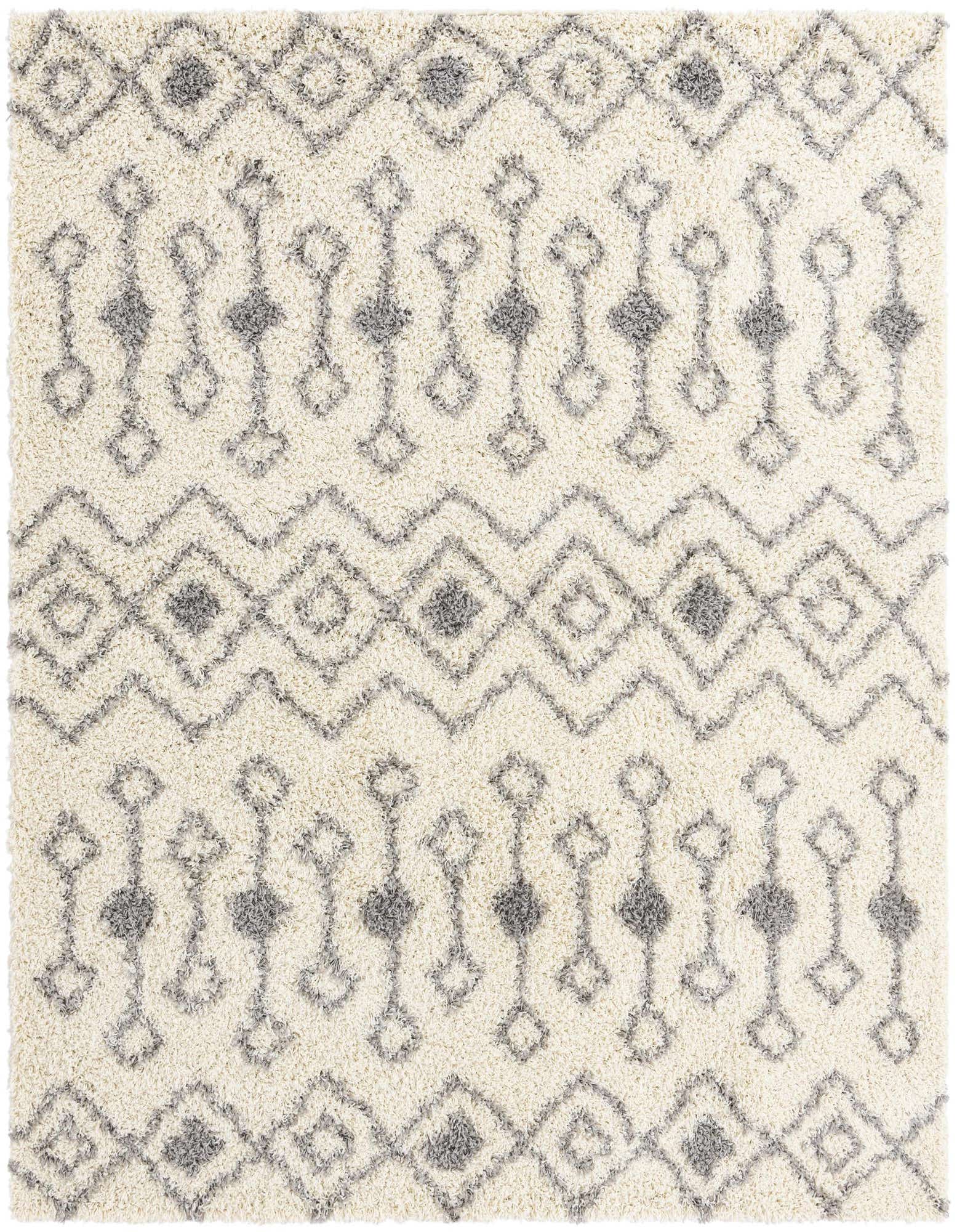 A square ivory shag rug with a modern tribal pattern in gray, featuring diamonds and zigzags.