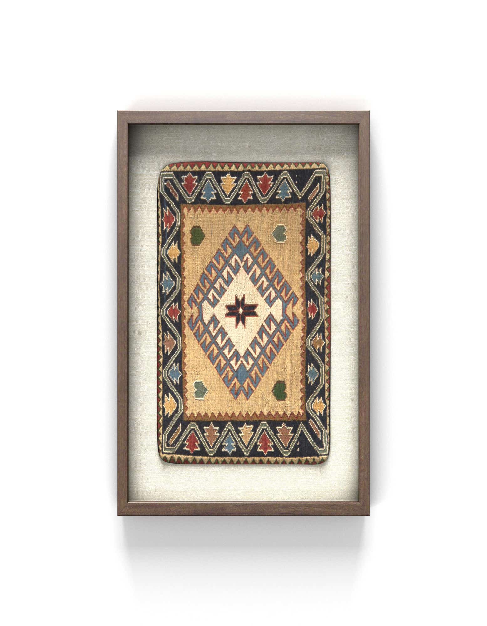 A framed square textile wall art piece featuring a vibrant geometric pattern in cream, red, blue, and black.