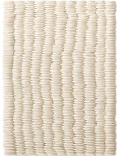 A long, narrow ivory runner rug with a textured, chunky felt ball design, ideal for a hallway or kitchen.