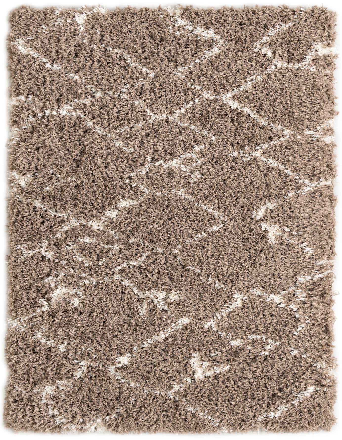 A rectangular 4x6 brown shag rug with a modern ivory geometric pattern, ideal for a living room.