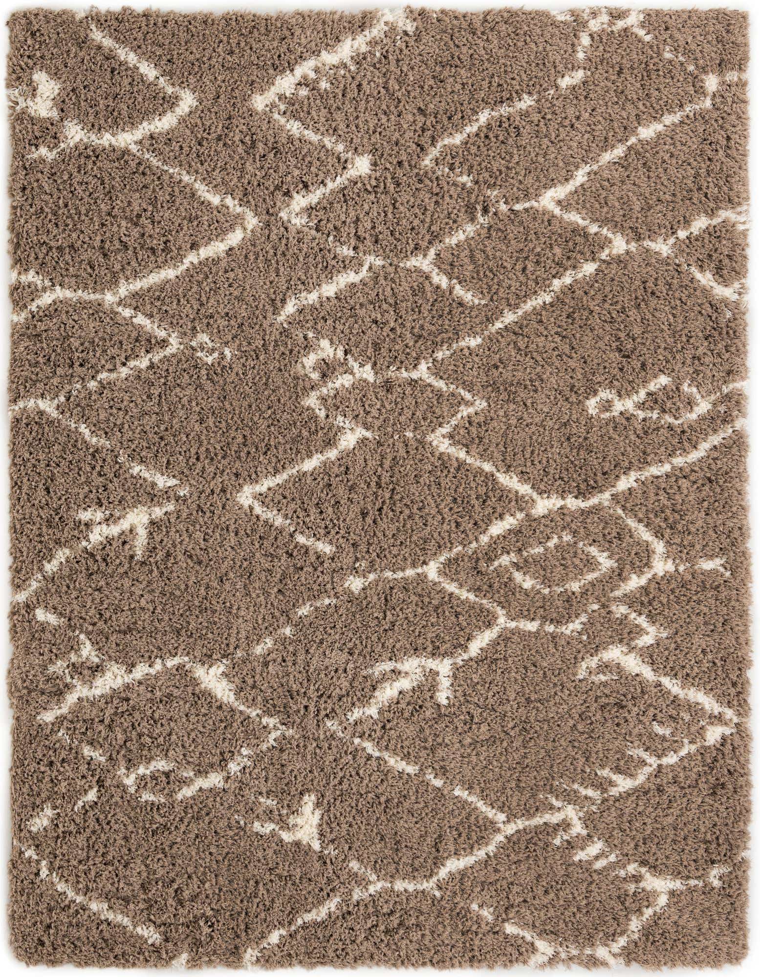 A rectangular 8x10 brown shag rug with an abstract ivory geometric pattern, suitable for a living room.