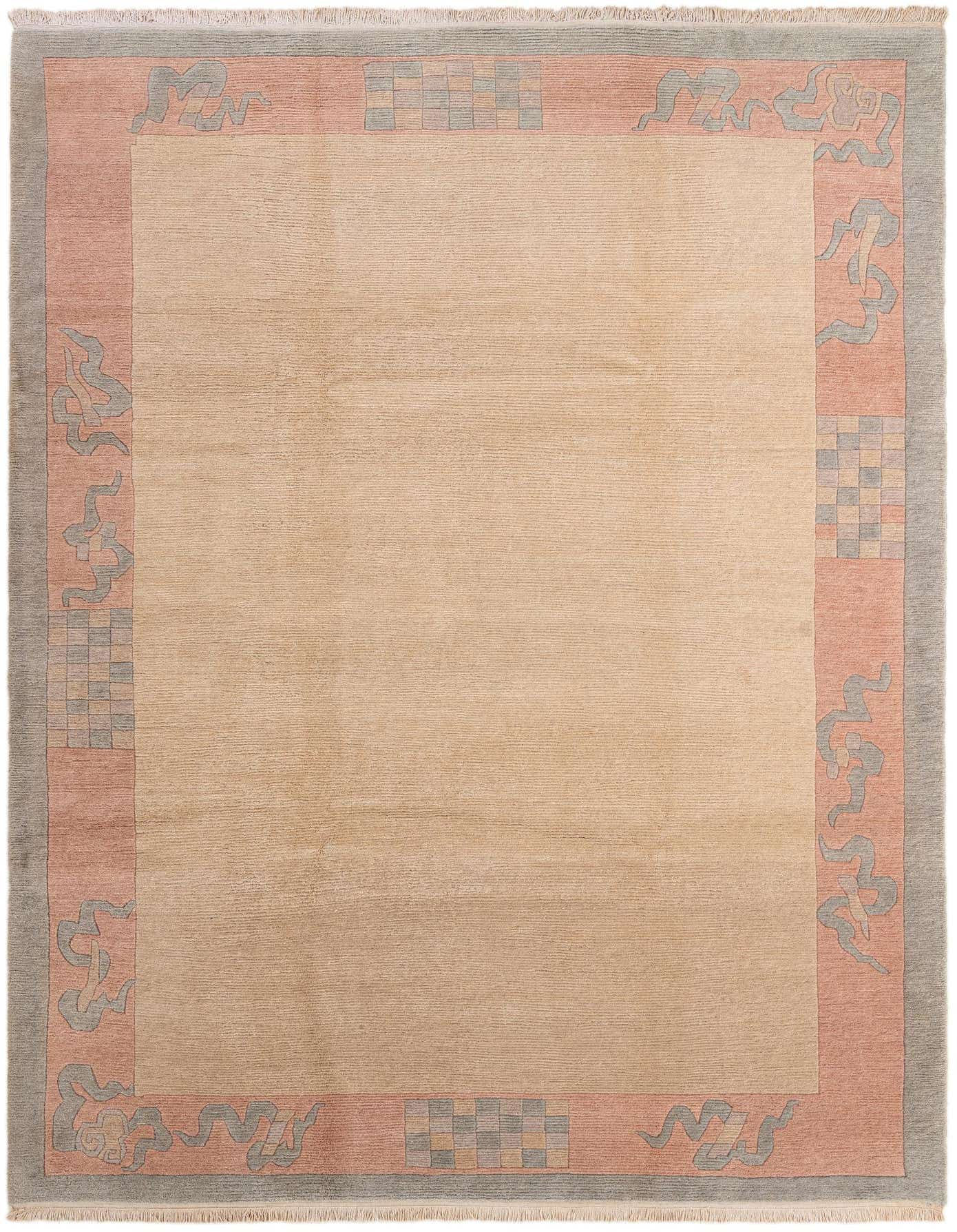 A rectangular 8x11 wool rug with a solid tan field and a wide border featuring coral, grey, and checkered patterns.
