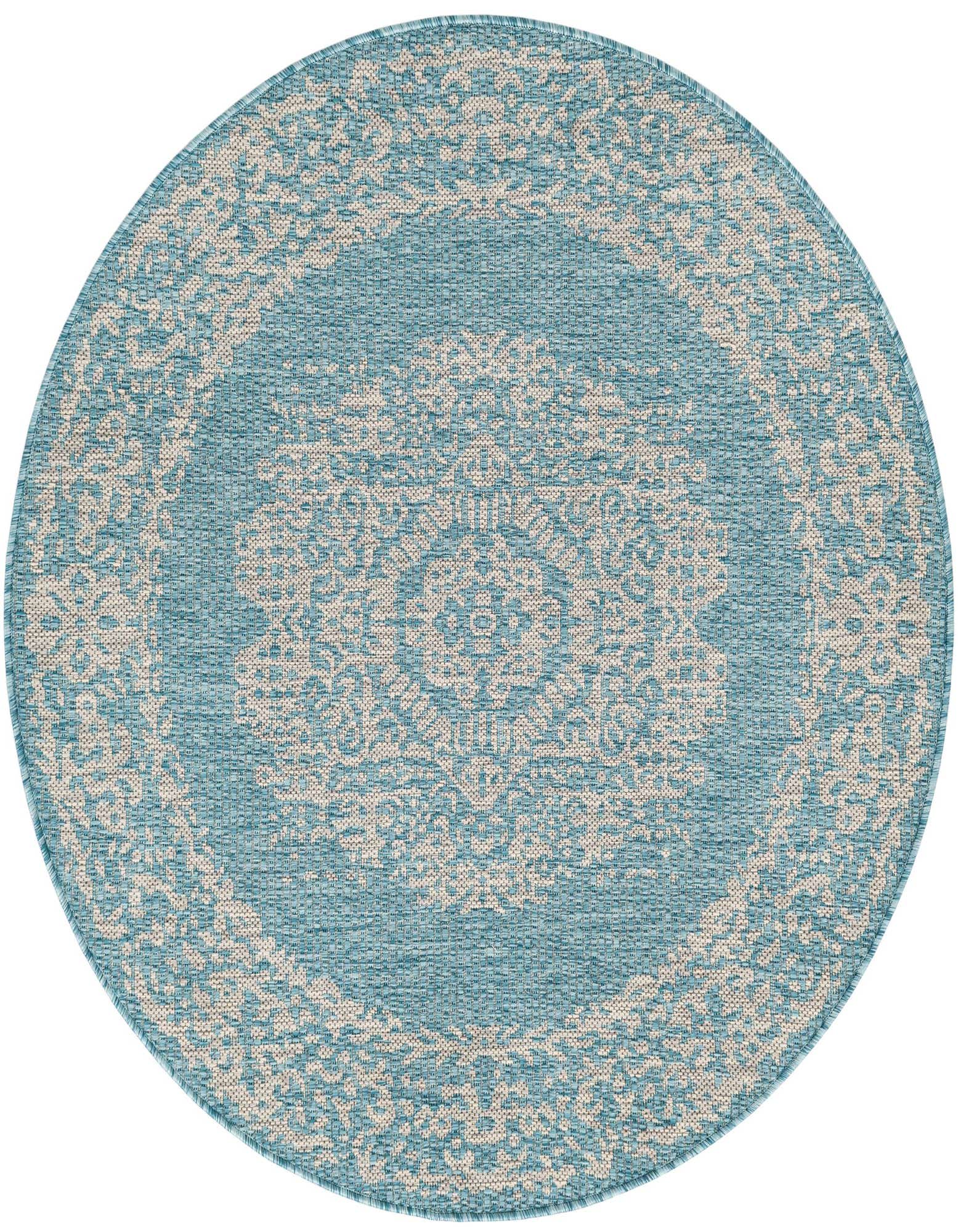 A 4' round light aqua indoor/outdoor rug with a cream Southwestern medallion pattern, ideal for a patio.