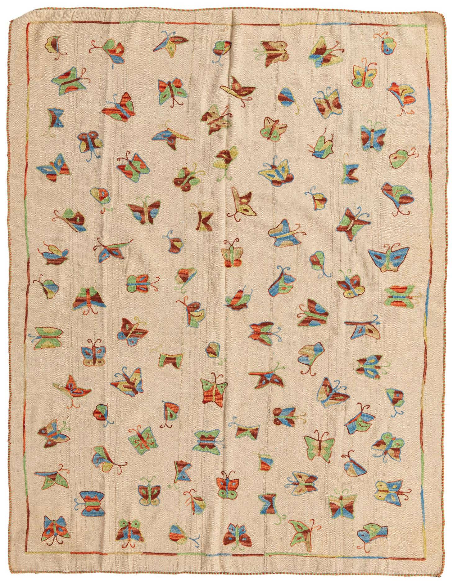 A 5x8 rectangular ivory flatweave wool rug with colorful scattered butterfly motifs in a tribal, modern style.
