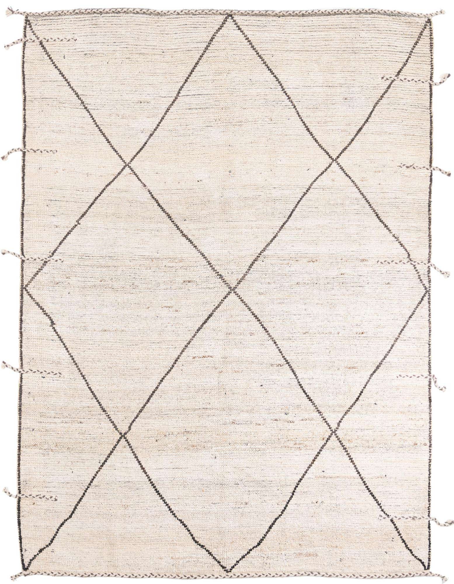 An 8x10 rectangular ivory shag rug with a black tribal diamond pattern and braided tassels.