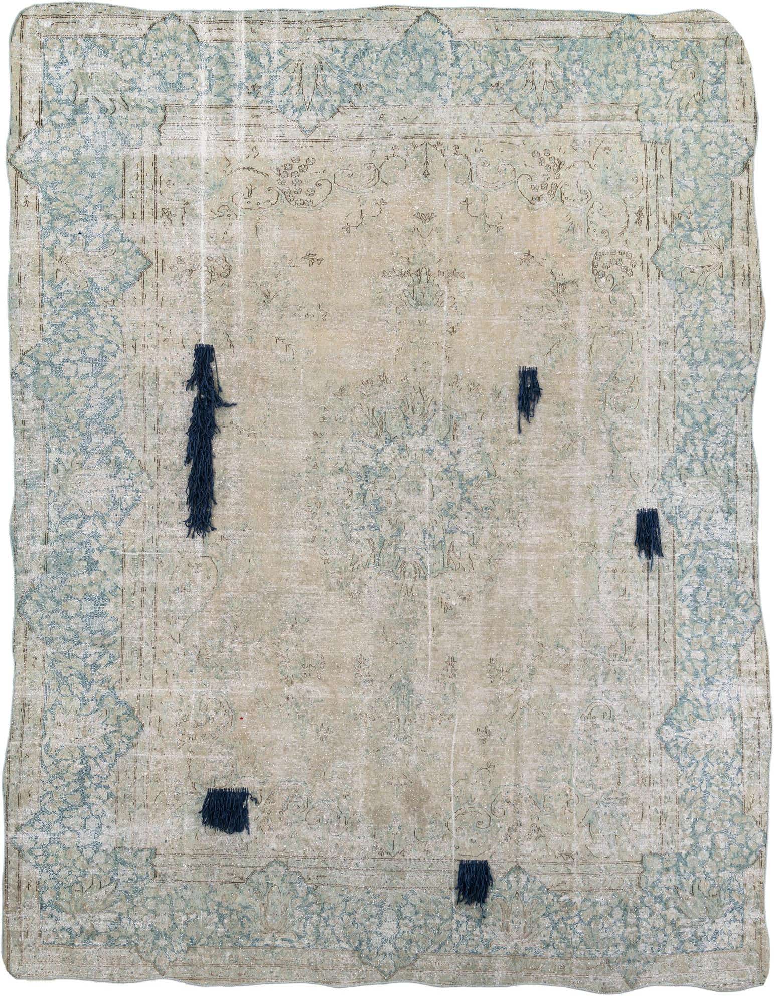 A 9x12 rectangular ivory and cream wool rug with a faded Persian medallion pattern and light blue border, featuring dark blue fringe accents.