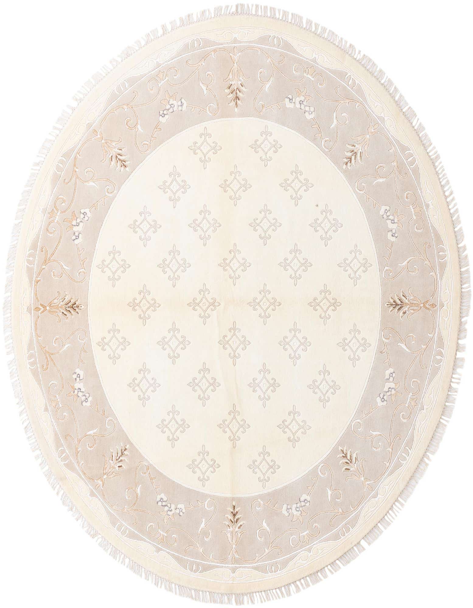 An 8' 3 round ivory wool rug with a subtle geometric pattern in the center and an ornate floral border.