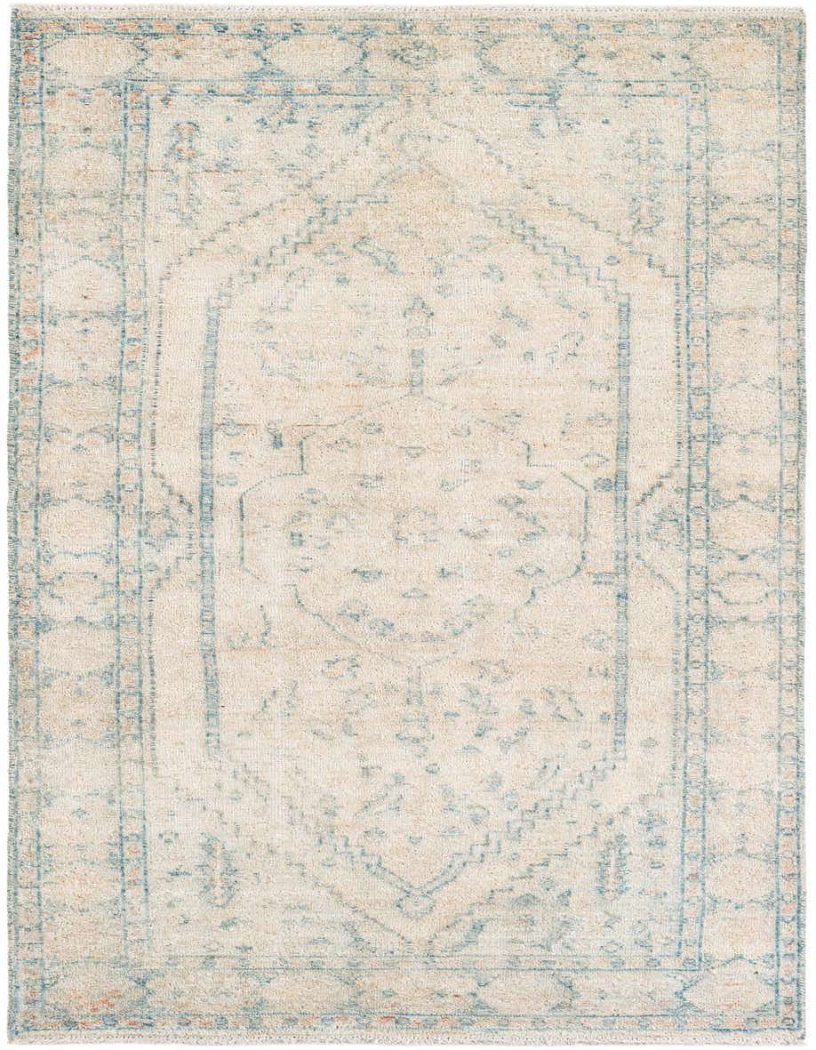 An 8 ft ivory runner rug with a faded blue tribal medallion pattern and shag pile, ideal for a hallway.