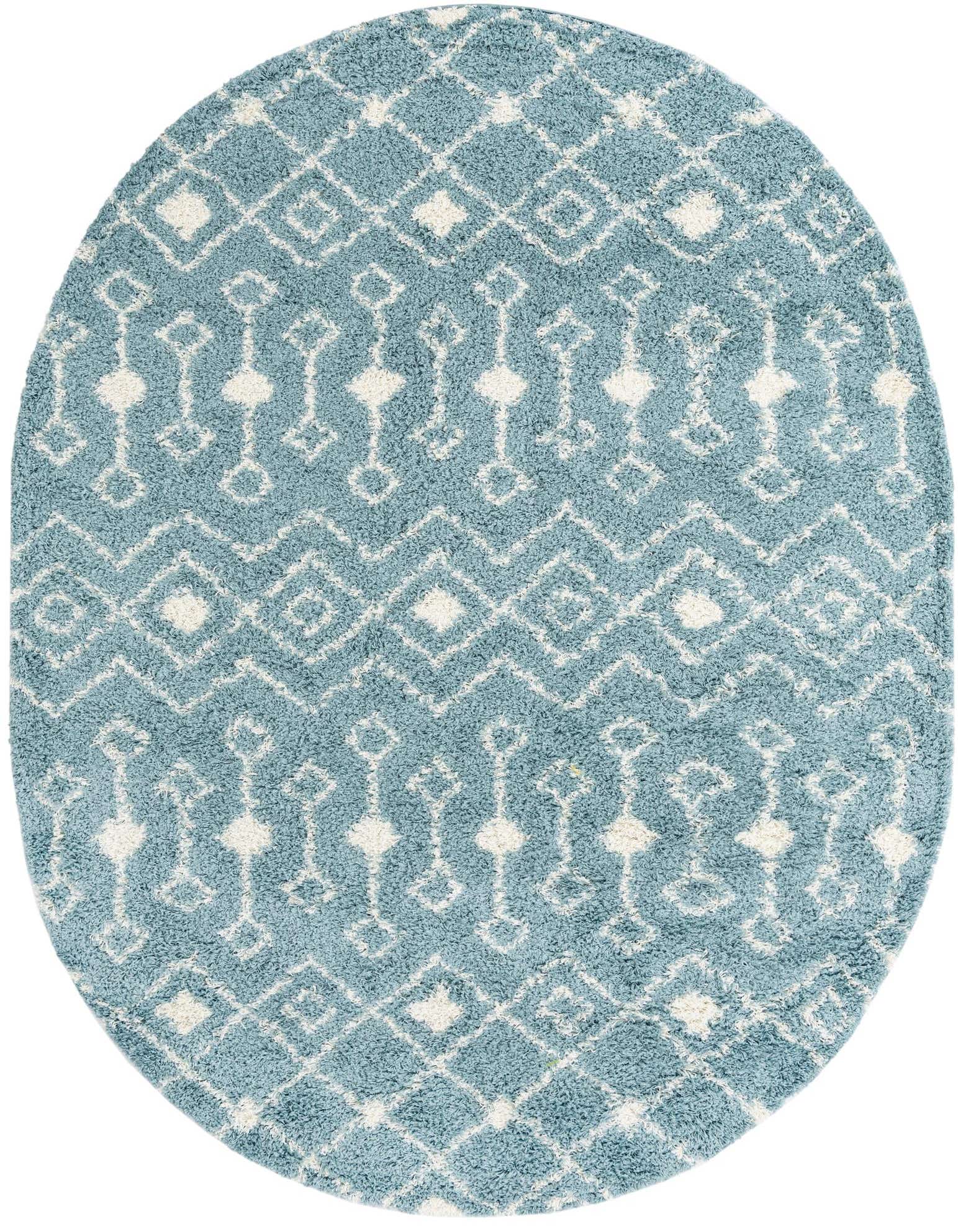A light blue oval shag rug with a white tribal geometric pattern, featuring diamonds and linked shapes.
