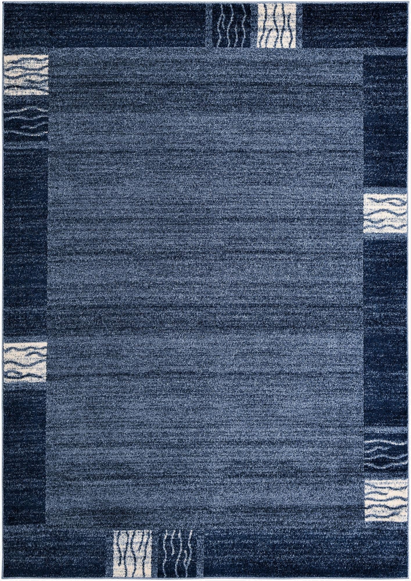 A 7x10 rectangular Rugs.com Angelica rug in varying shades of blue with a contemporary border pattern, suitable for a living room.
