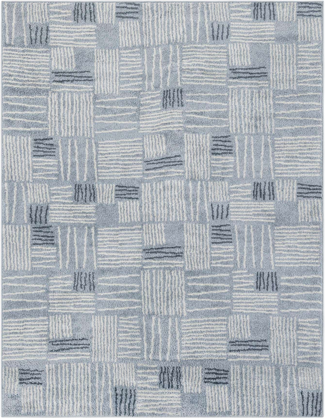 A 5x8 rectangular Hanahan rug with a modern abstract pattern in shades of light blue, white, and dark blue, featuring a medium pile.