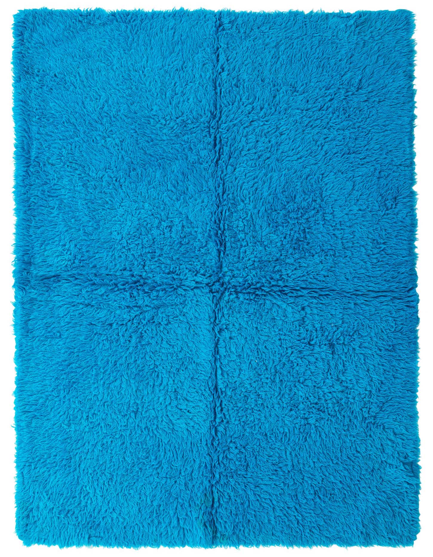 A rectangular 5x8 light blue shag rug with a plush, textured pile, perfect for a modern living room.