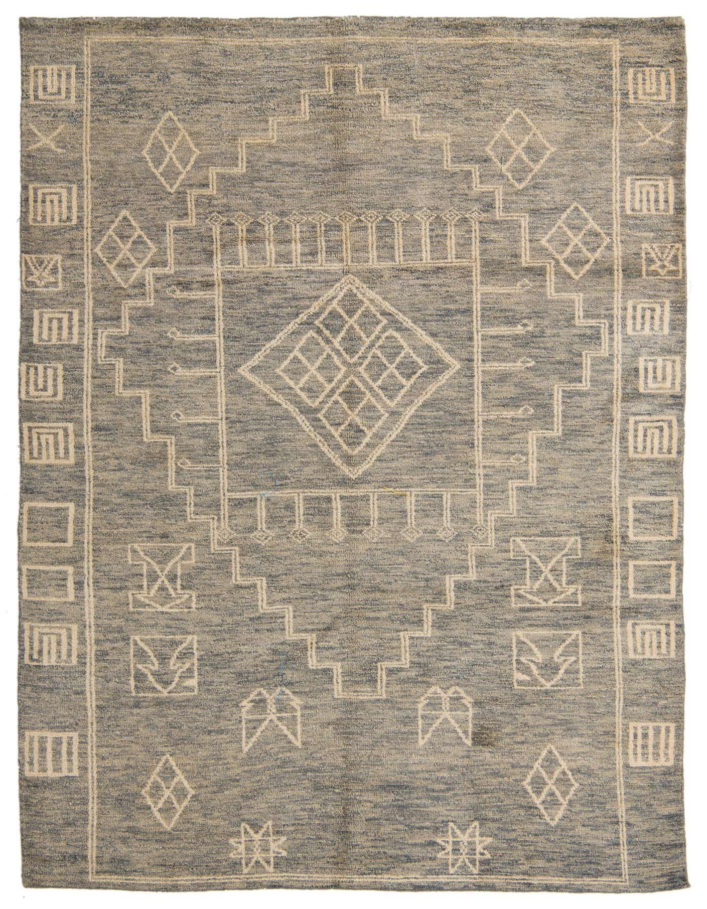A 6x9 rectangular light blue wool shag rug with a modern tribal pattern featuring geometric shapes and lines.