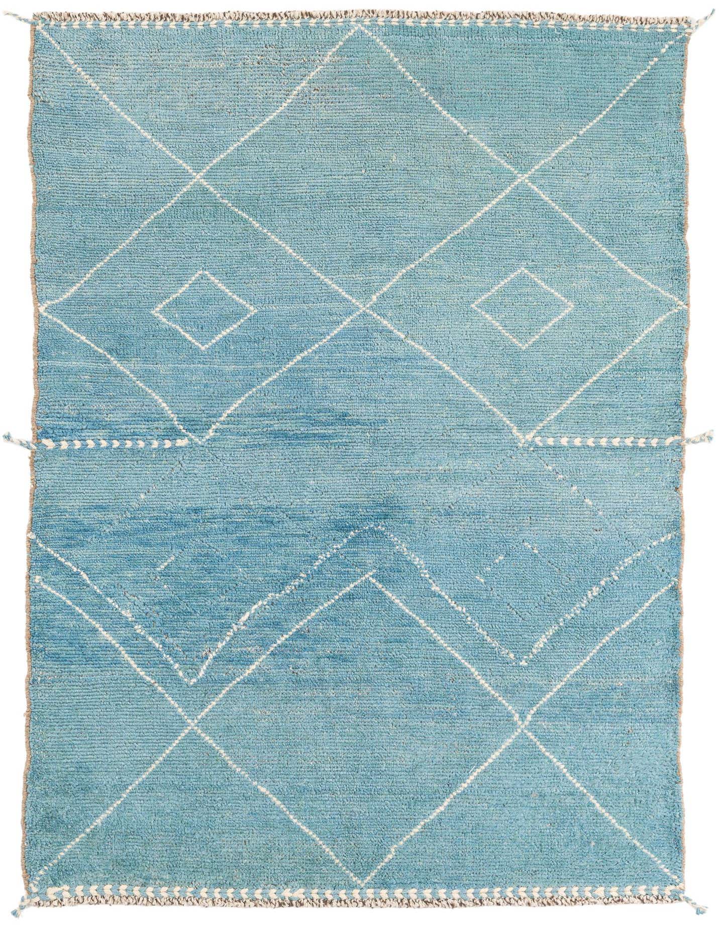 A 4x6 rectangular light blue shag rug with a white tribal diamond and zigzag pattern, suitable for a living room.