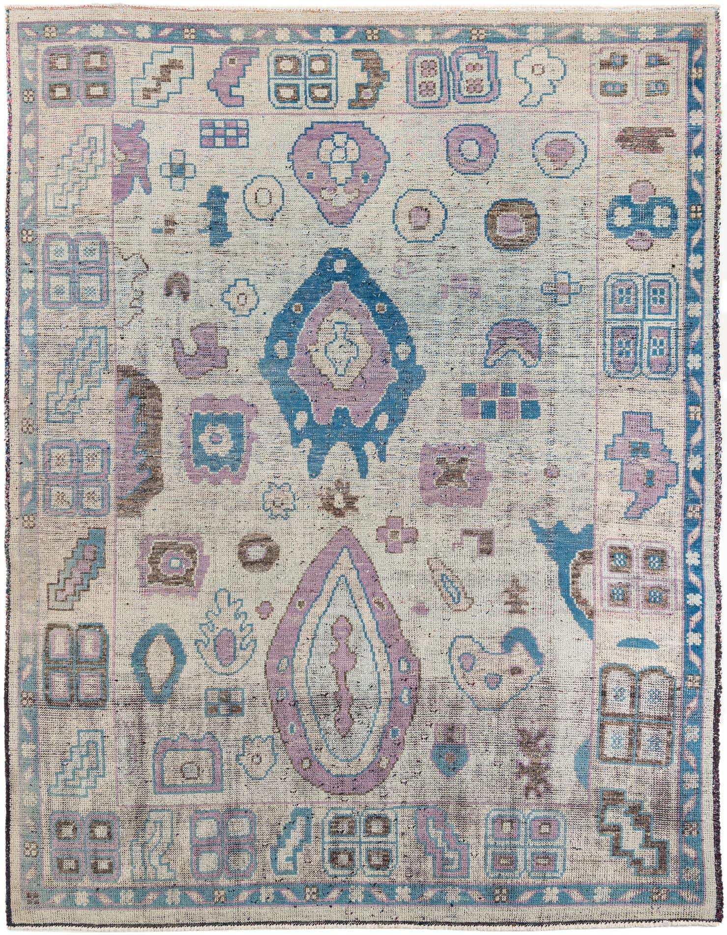 A 9x12 rectangular Rugs.com Moroccan rug with a light blue and purple tribal pattern on a cream background, suitable for a living room.