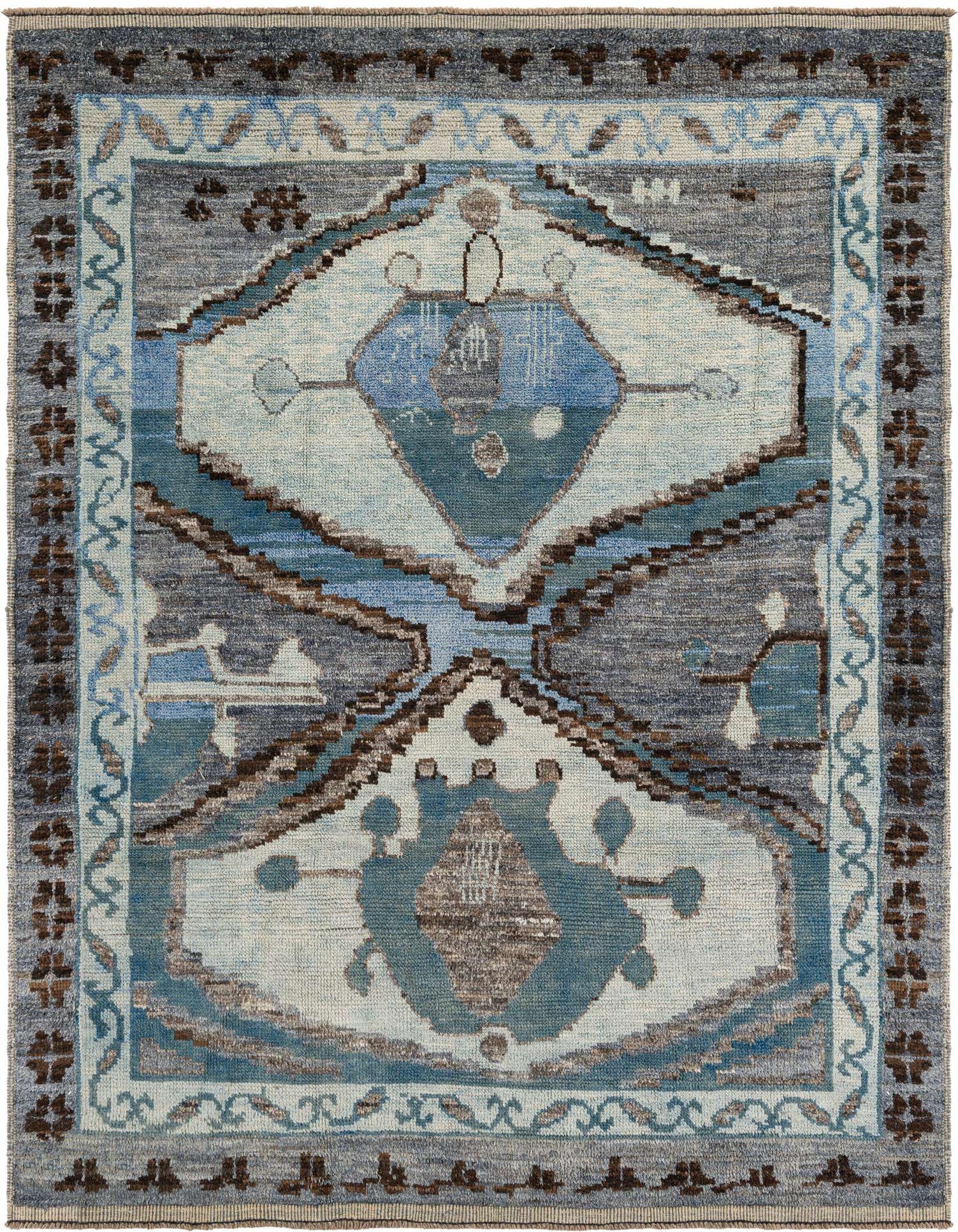 An 8x11 rectangular Moroccan wool rug featuring a central medallion in various blues, surrounded by tribal patterns and a border, on a textured gray background.