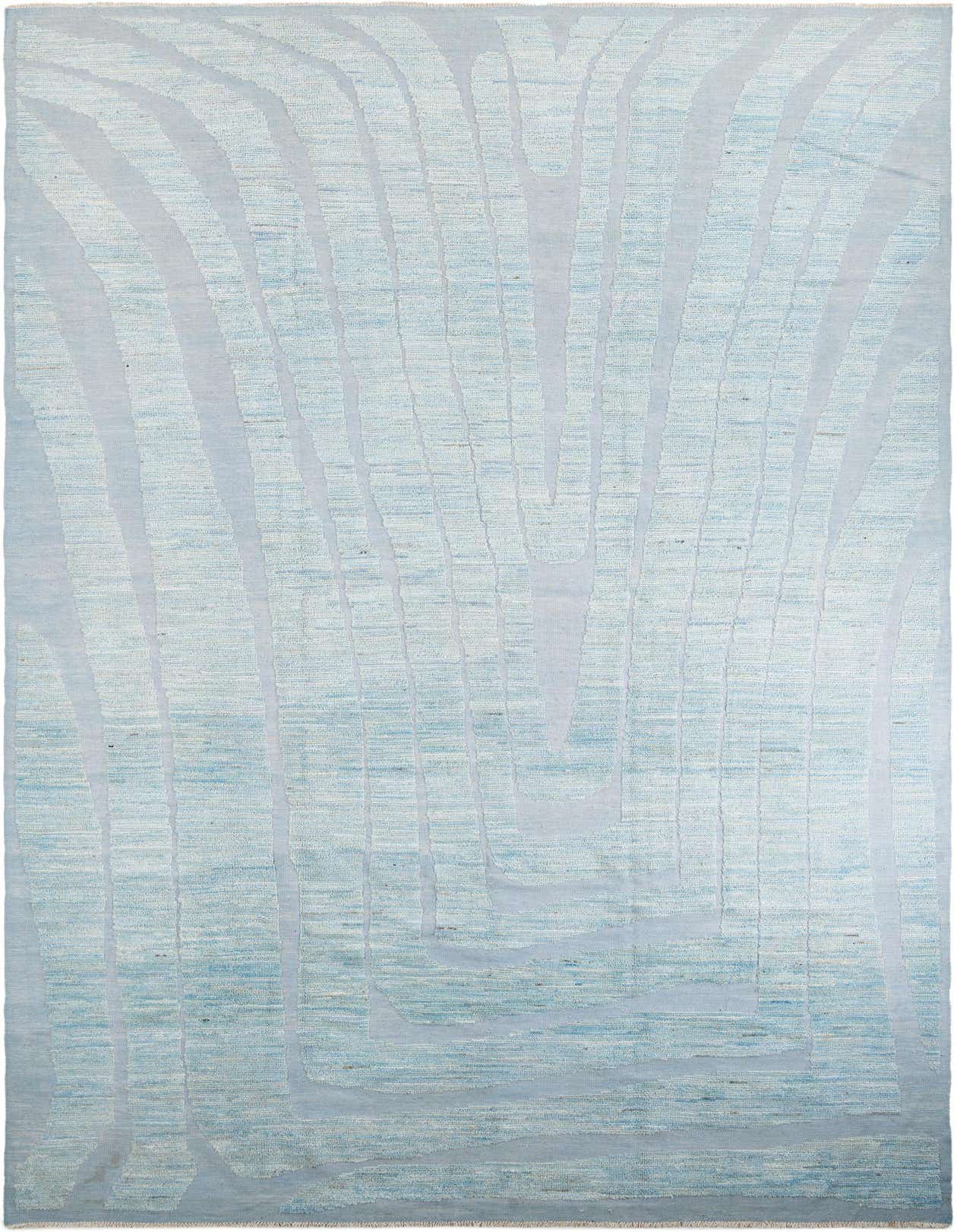 A large 10x14 rectangular light blue wool shag rug with an abstract tribal pattern, ideal for an indoor living space.