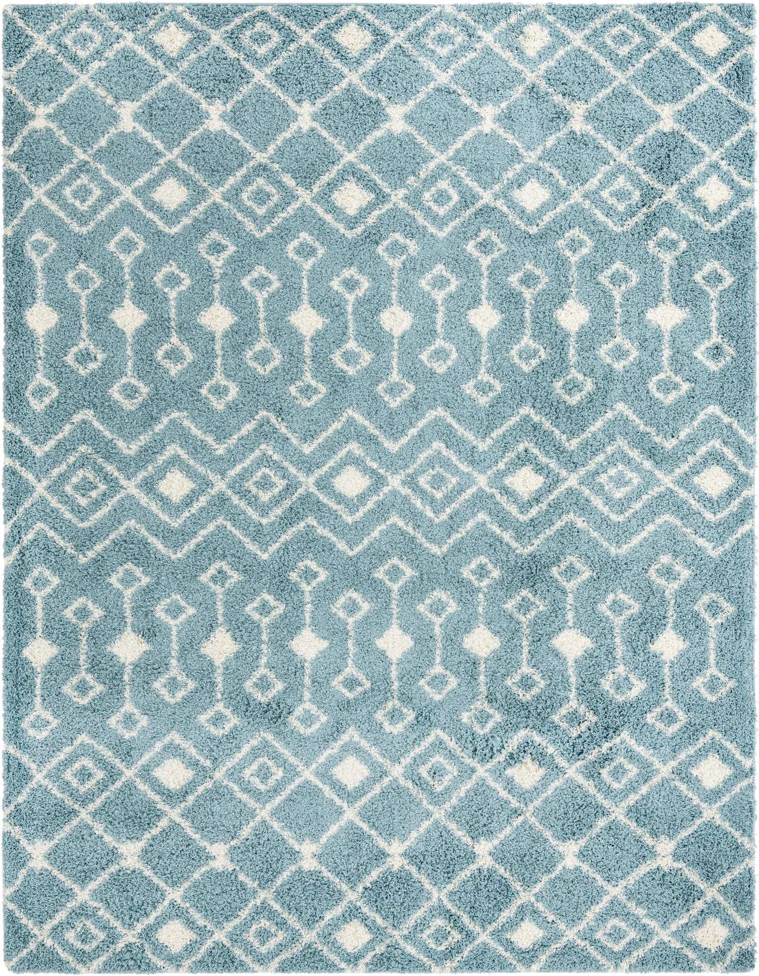 A 10x13 rectangular light blue shag rug featuring a modern tribal pattern of white diamonds and geometric shapes.
