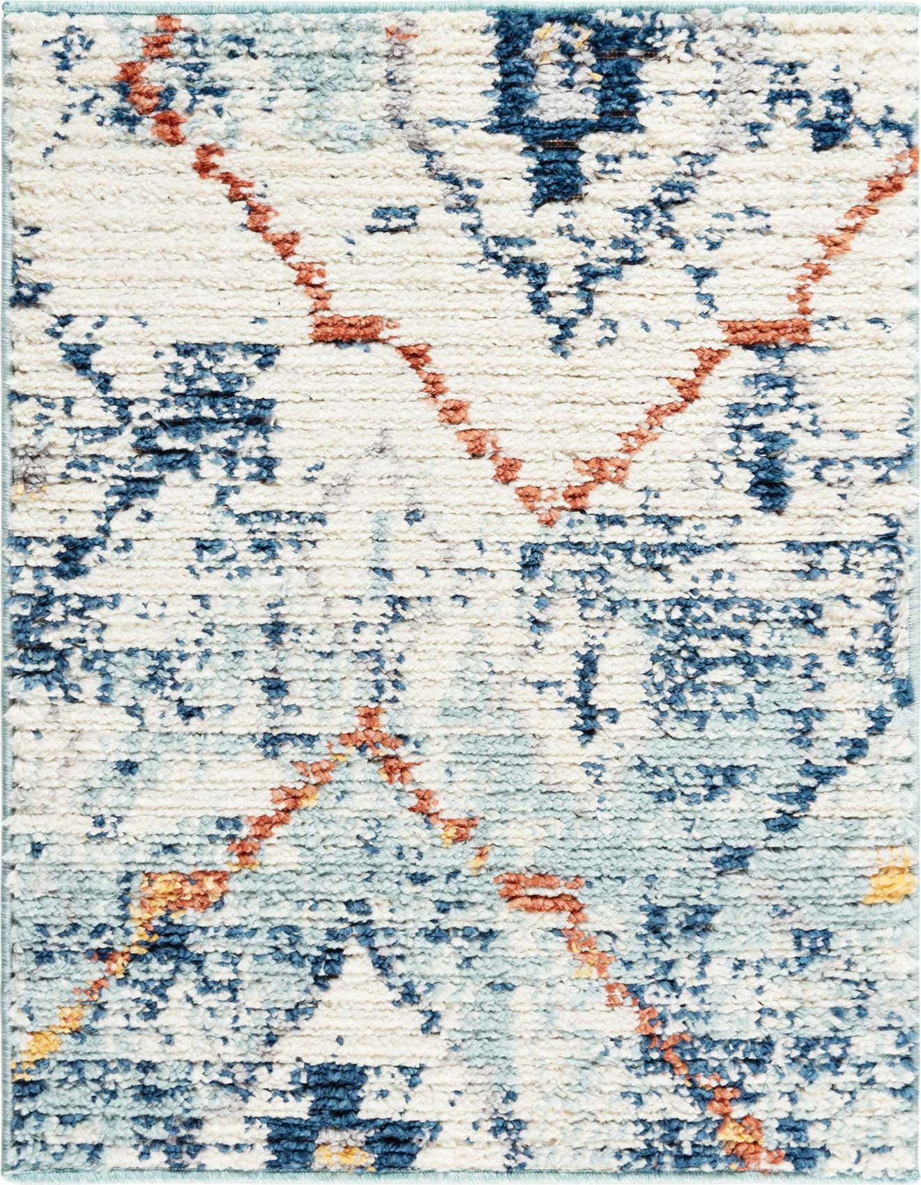 A close-up of a 2x3 rectangular shag rug featuring a distressed bohemian pattern in shades of blue, white, and orange.
