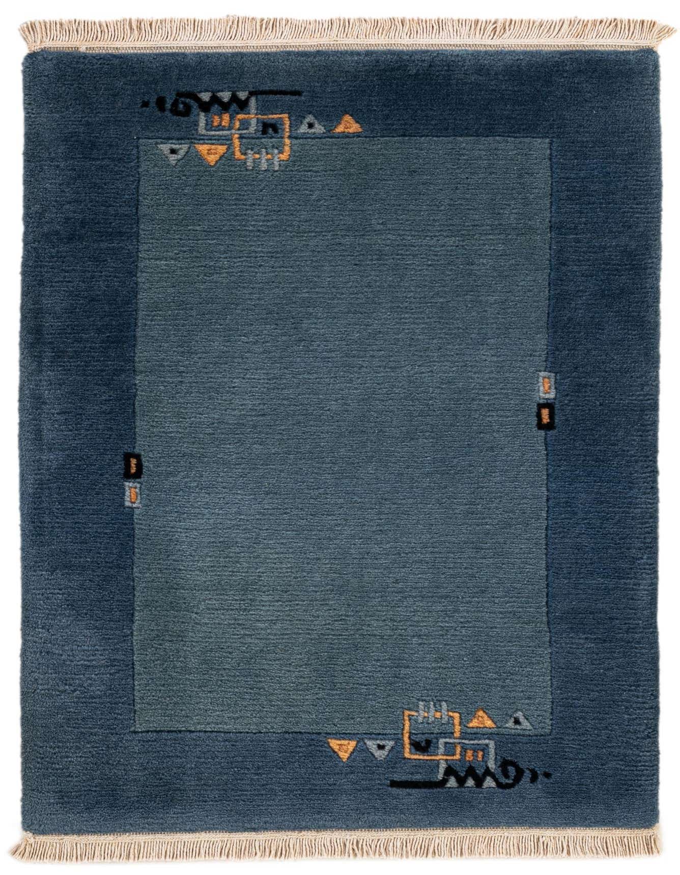 A 2x3 rectangular Nepal collection rug in varying shades of blue, featuring an abstract modern pattern with geometric shapes and lines in orange and black, and fringed ends.