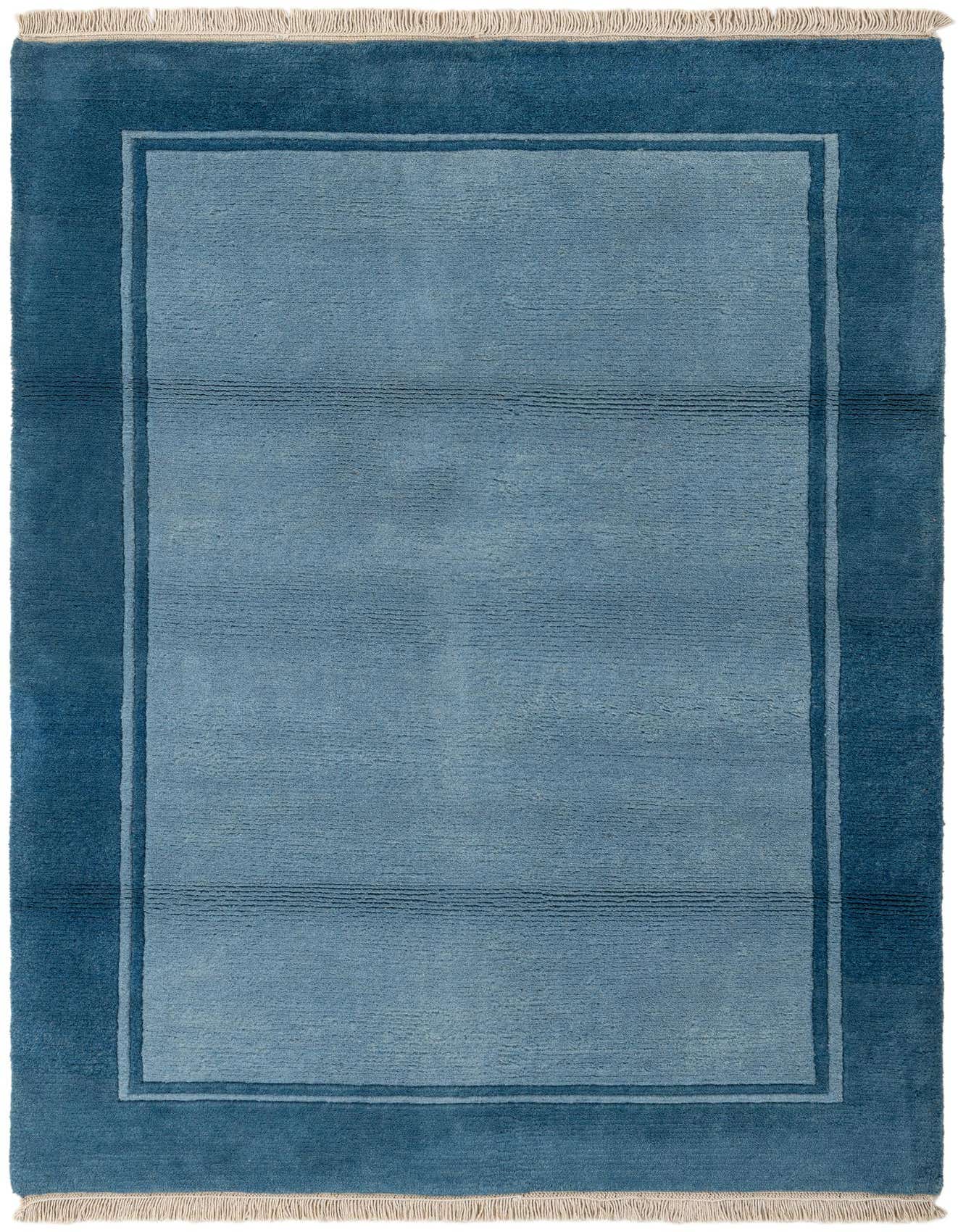 A 4x6 rectangular Nepal Collection wool rug featuring a light blue center with subtle horizontal lines and a deep blue border, suitable for a living room.