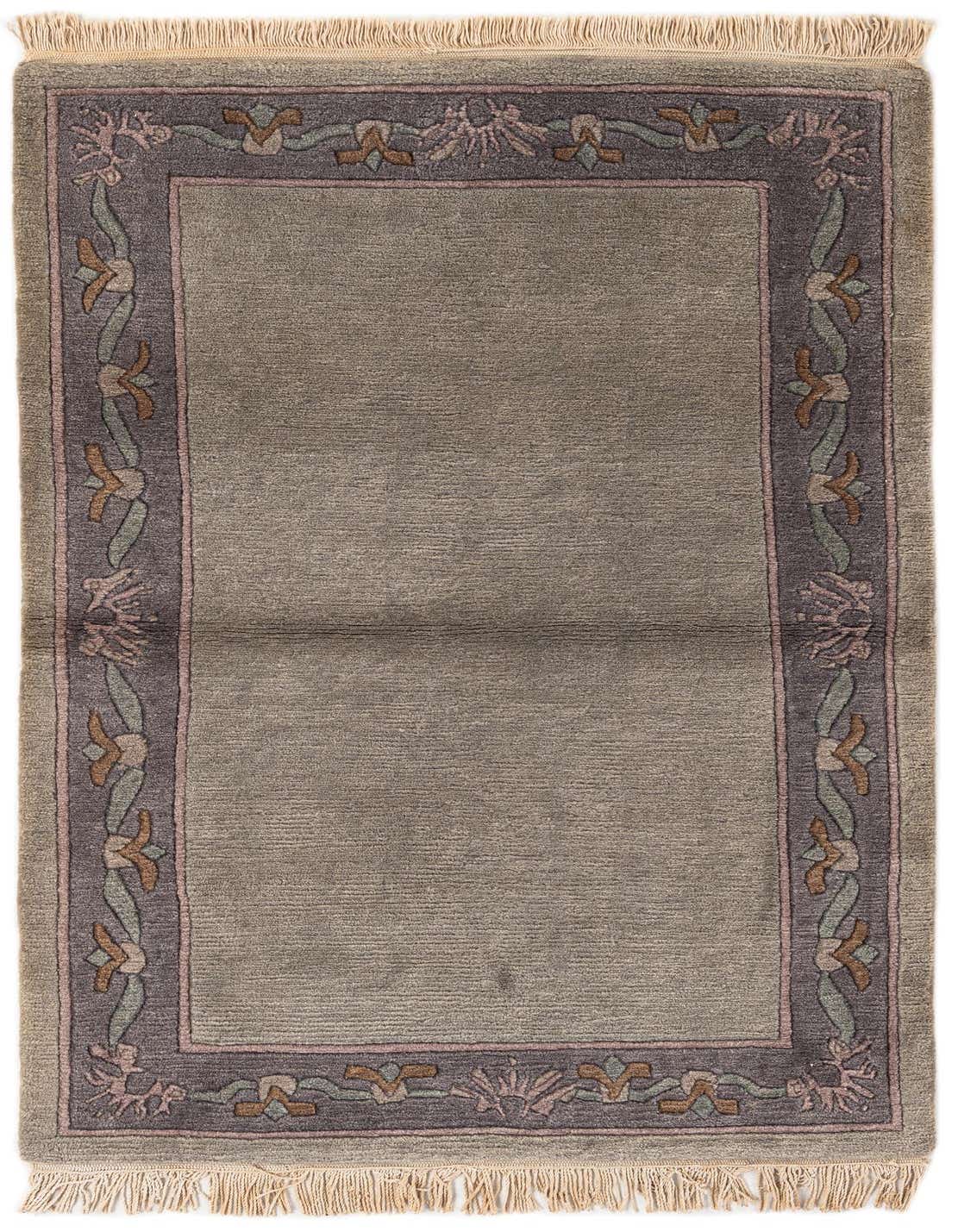 A 3x5 rectangular light blue wool rug with a dark blue and pink floral border, featuring fringe.