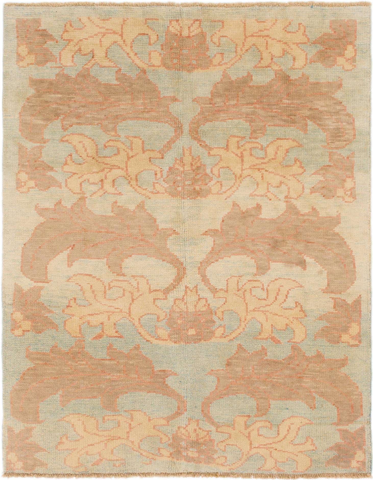 A 5x7 rectangular light blue wool area rug with an abstract tribal pattern in peach and cream tones.