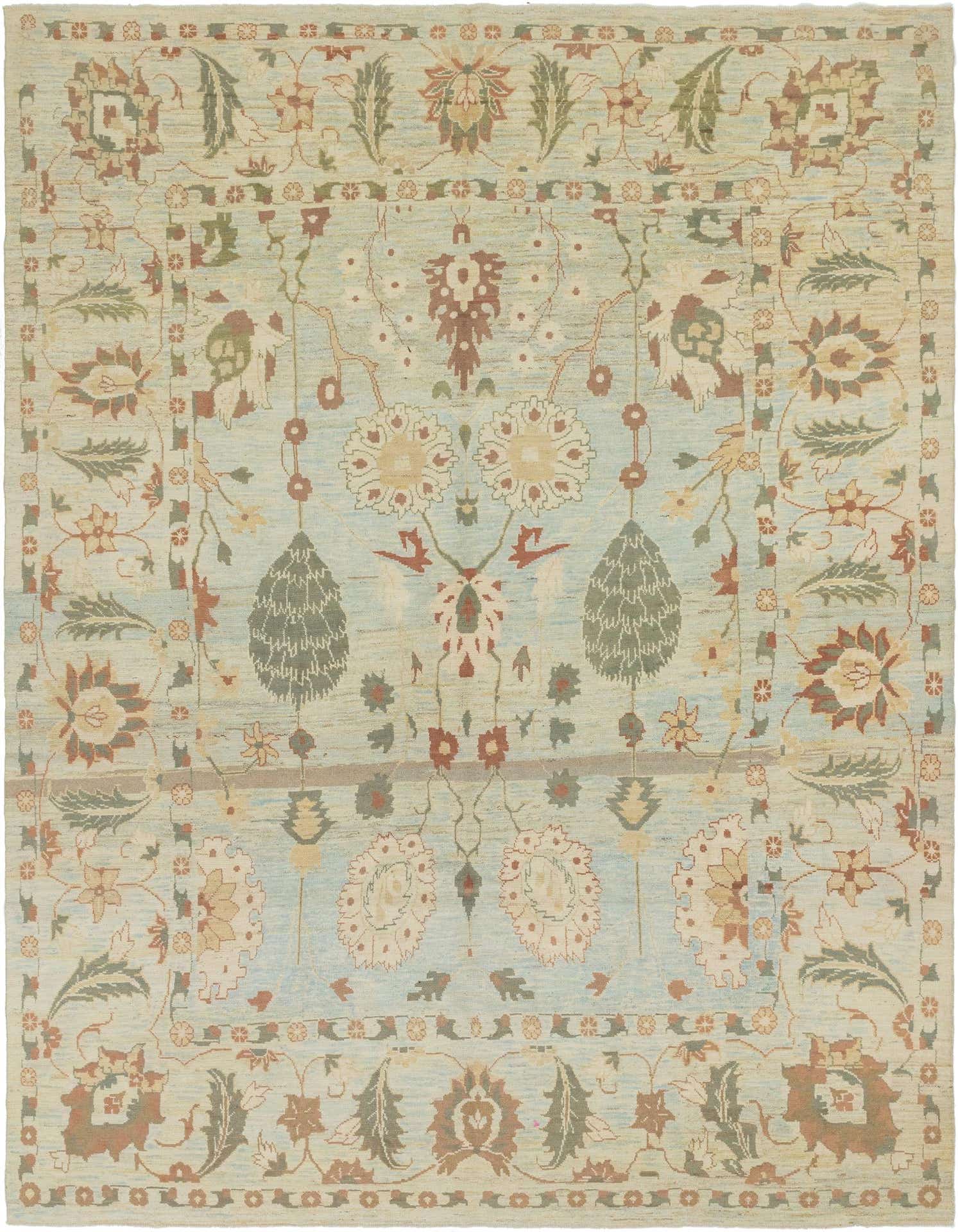 A 12x16 light blue rectangular wool Oushak rug with a transitional floral and tribal pattern in muted earth tones.