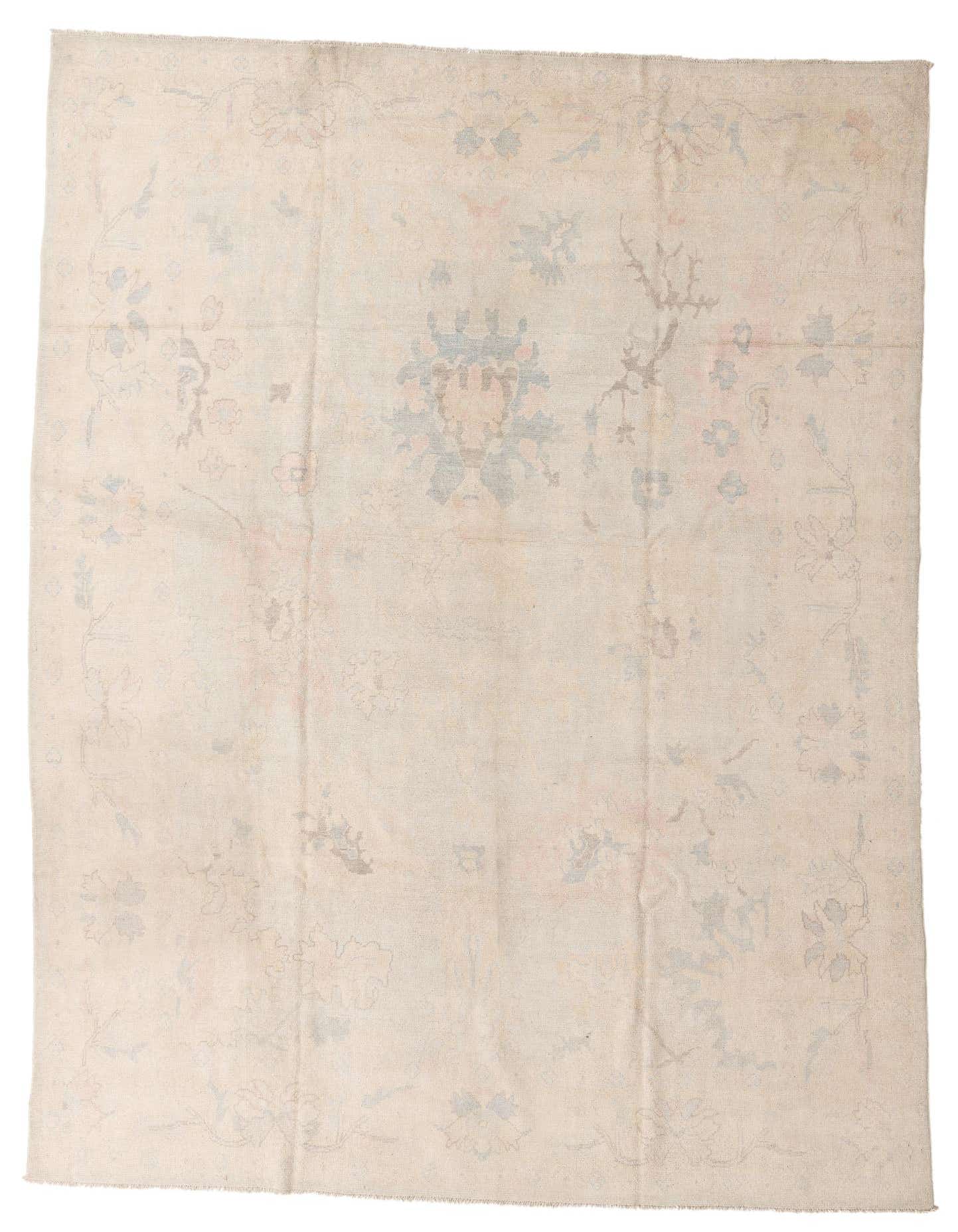 A 10x14 rectangular Oushak wool rug in light blue and cream with a subtle floral and border pattern.