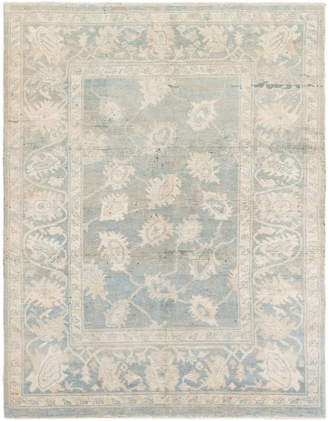 A 5x8 rectangular light blue modern Oushak wool rug with an intricate floral and vine pattern in cream.
