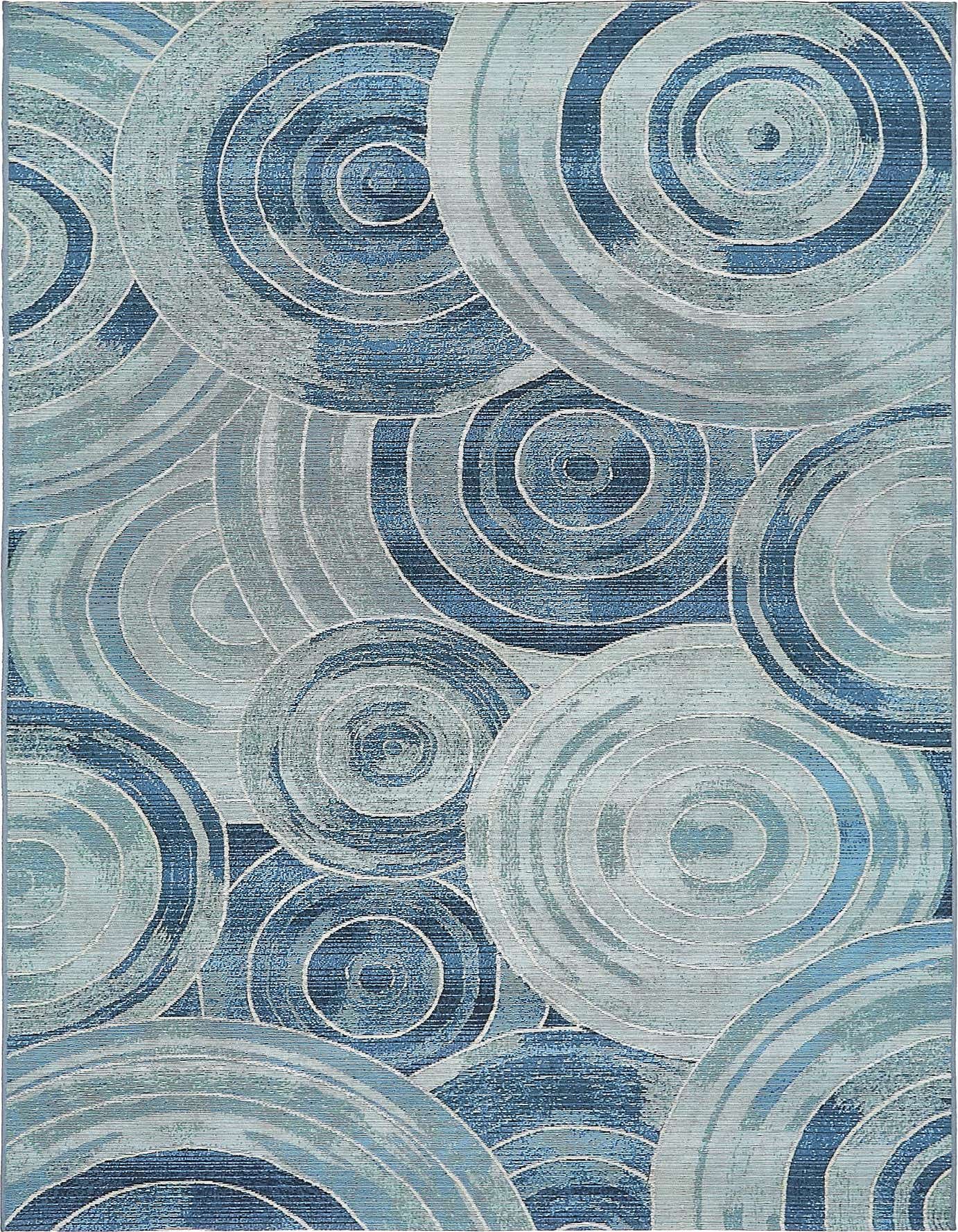 A 5x8 rectangular indoor/outdoor rug featuring an abstract coastal pattern of overlapping blue and light blue concentric circles.