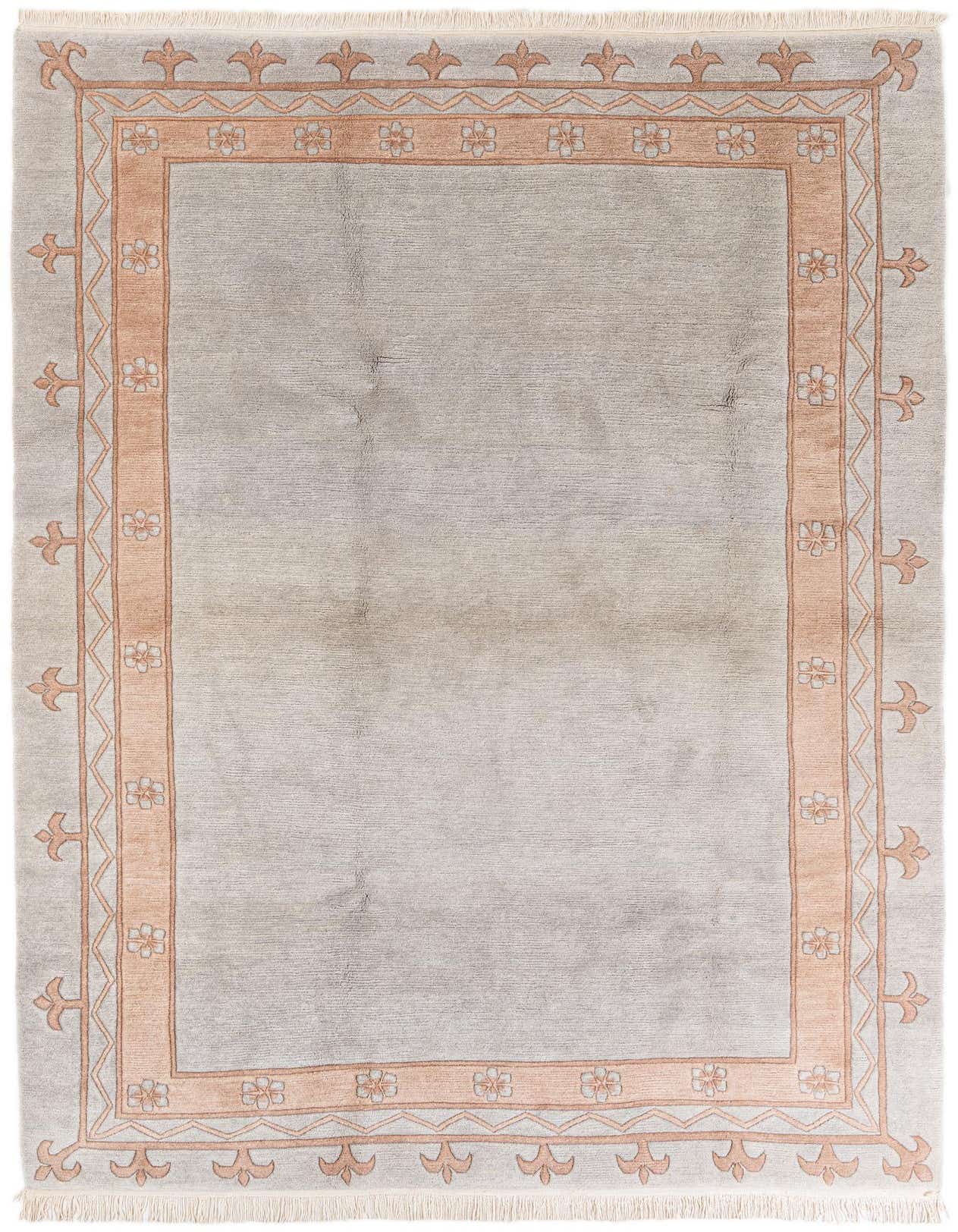 A 7x10 rectangular light blue wool area rug with a peach-colored modern floral and geometric border, suitable for a living room.