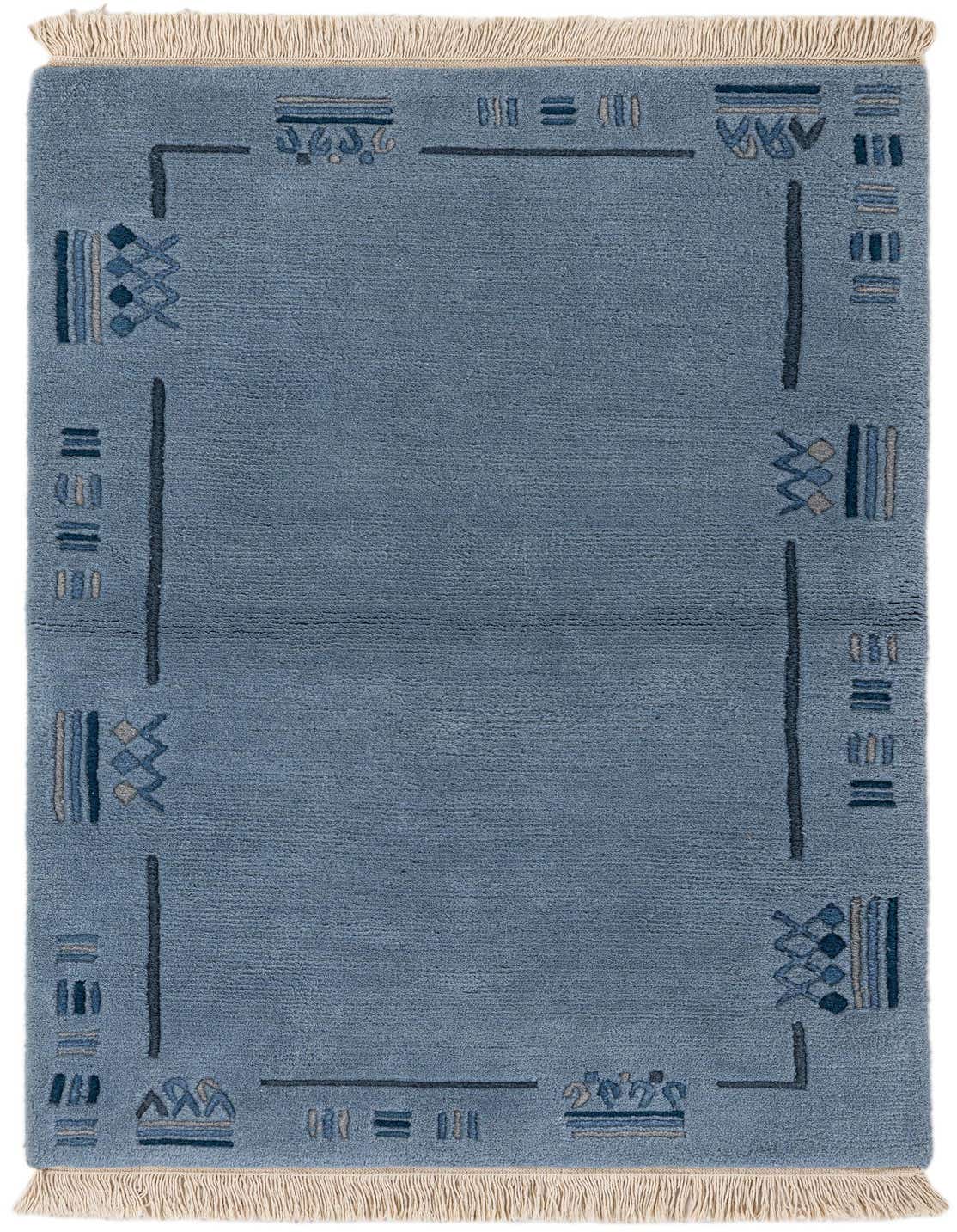A 3x5 rectangular light blue wool rug with a modern abstract border pattern in varying shades of blue and grey, featuring cream fringes.
