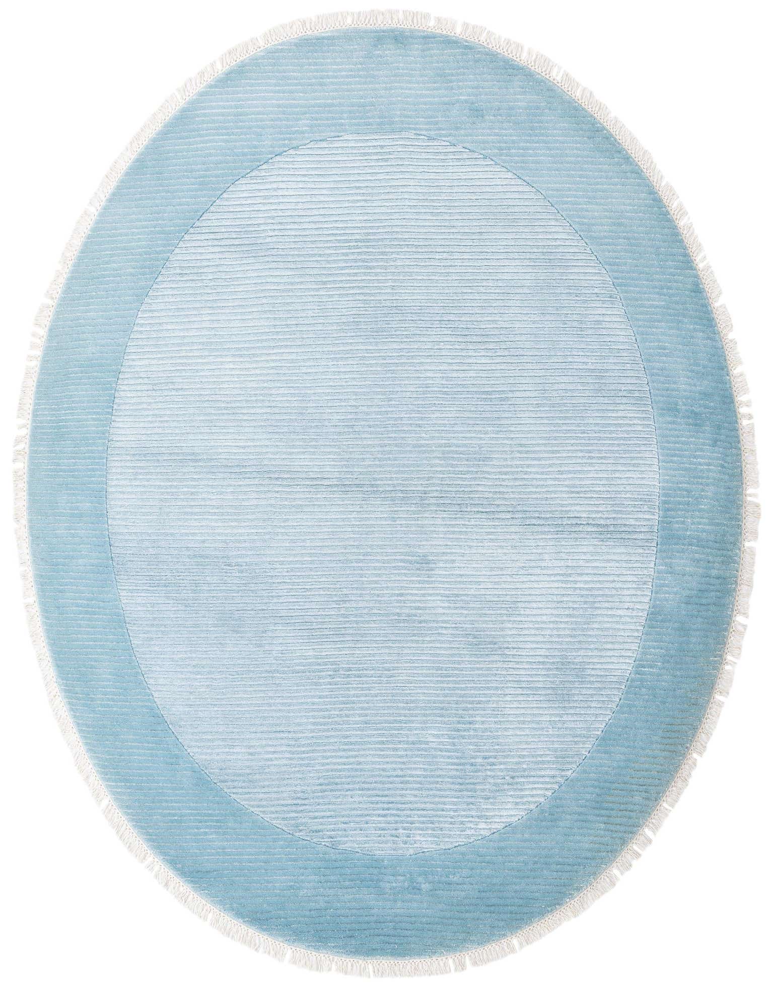 A round, light blue wool rug with a subtle striped pattern and a darker blue border, featuring white fringe.
