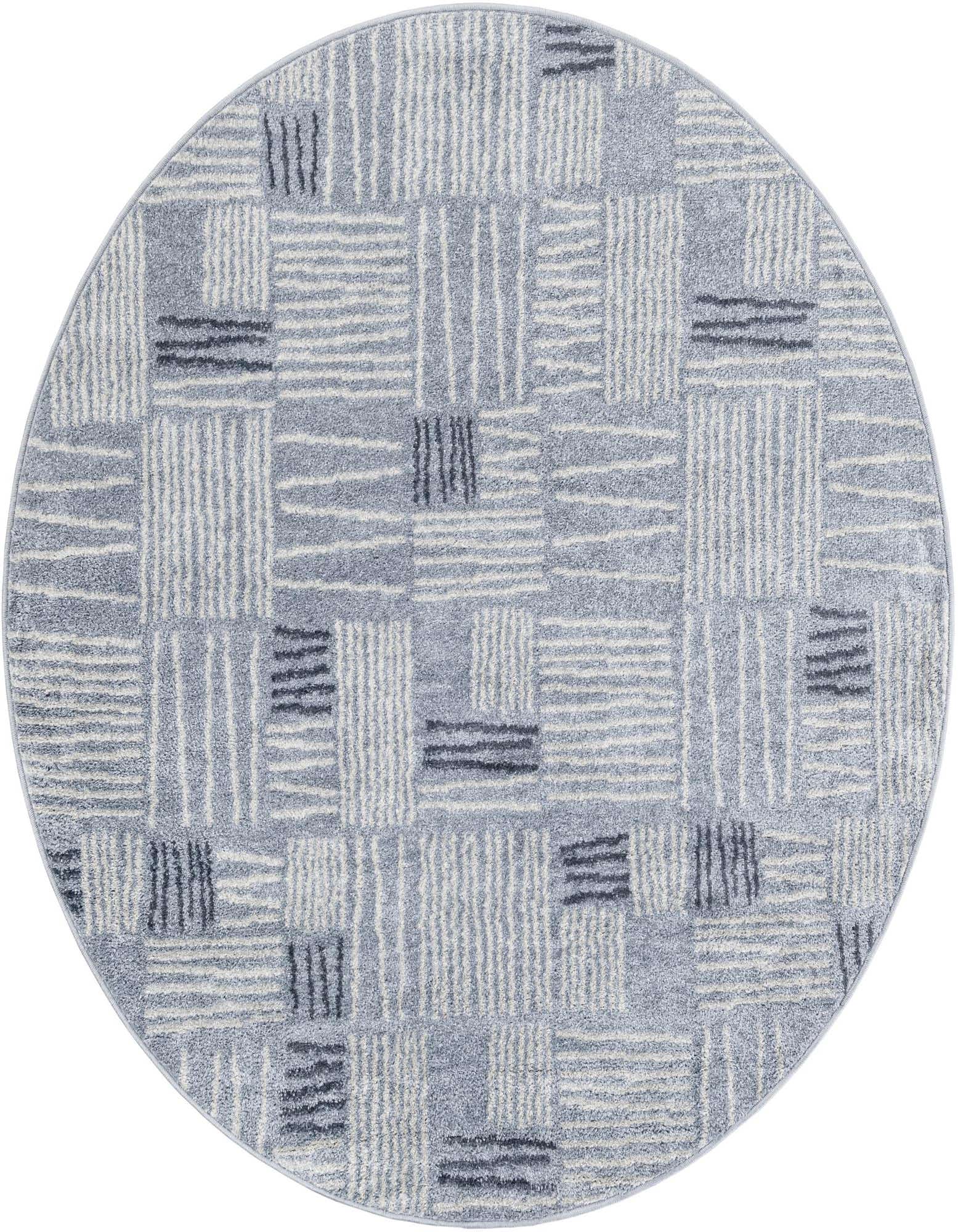 A 5' 3 round light blue modern rug with an abstract pattern of white and dark blue lines creating a geometric block design.