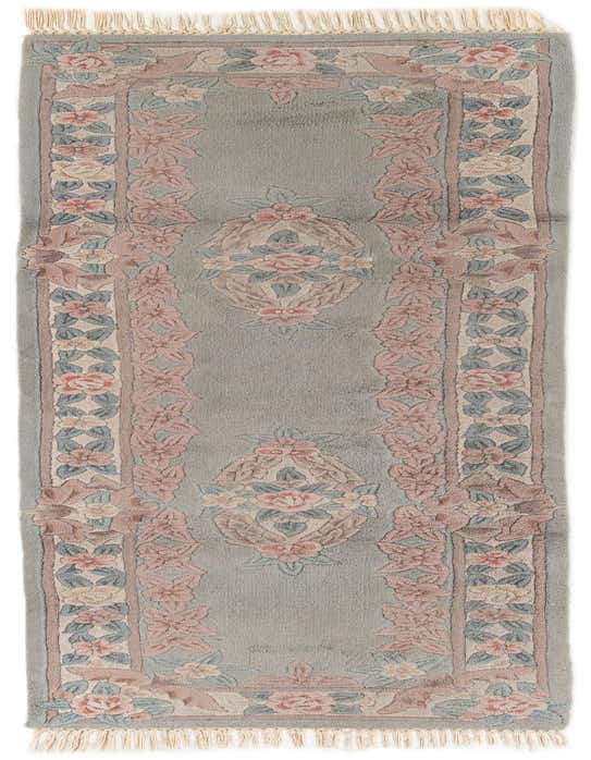 A light blue 9 ft runner rug with an intricate pink and cream floral Oriental pattern, perfect for a hallway.