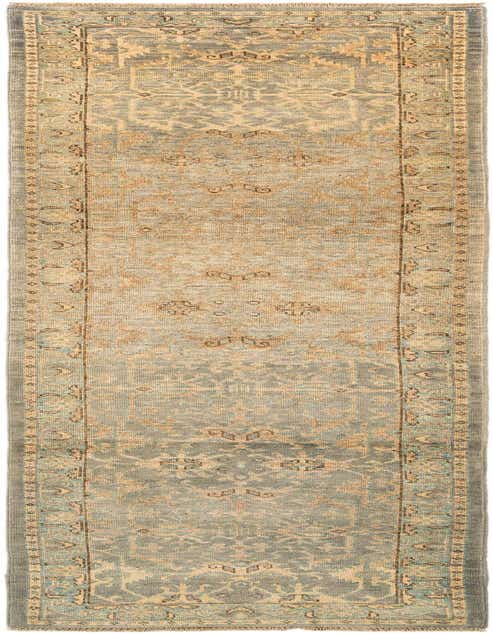 A 10 ft handmade wool runner rug in varying shades of blue and beige with a traditional pattern, suitable for a hallway.