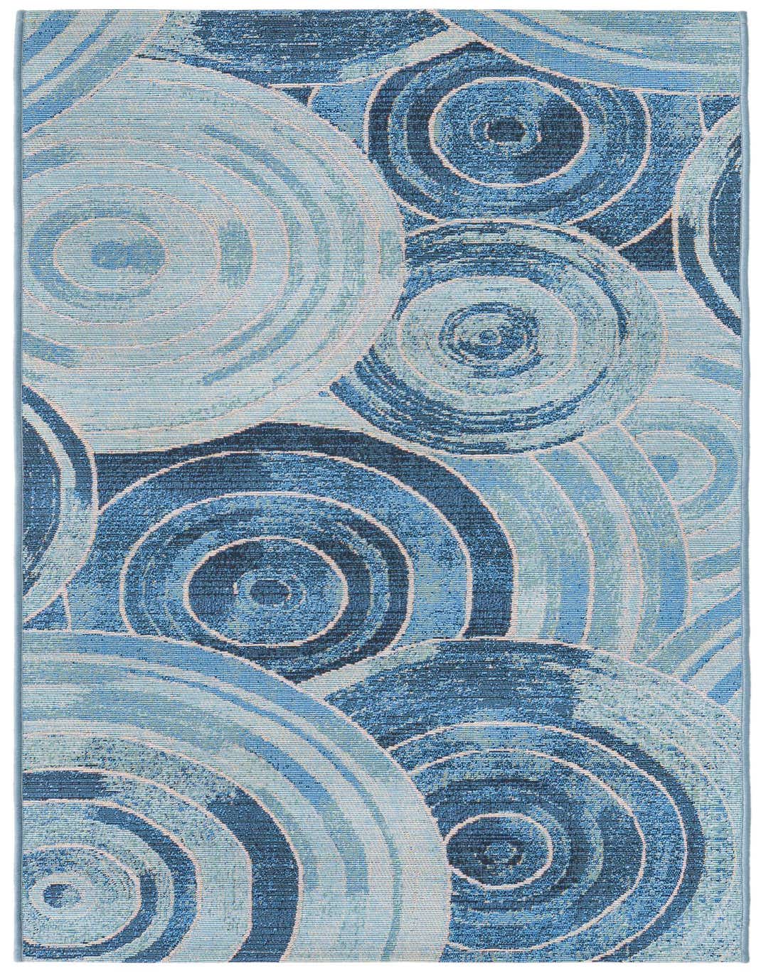 A 5 ft runner rug featuring an abstract coastal pattern of concentric circles in various shades of blue.