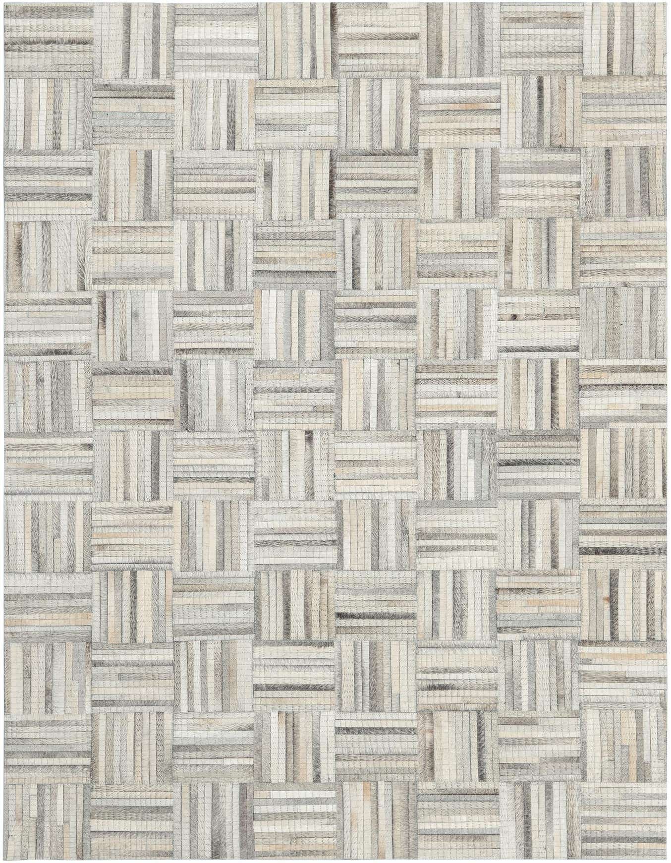 A 4x6 light brown and ivory rectangular modern cowhide and leather rug with an abstract patchwork pattern.