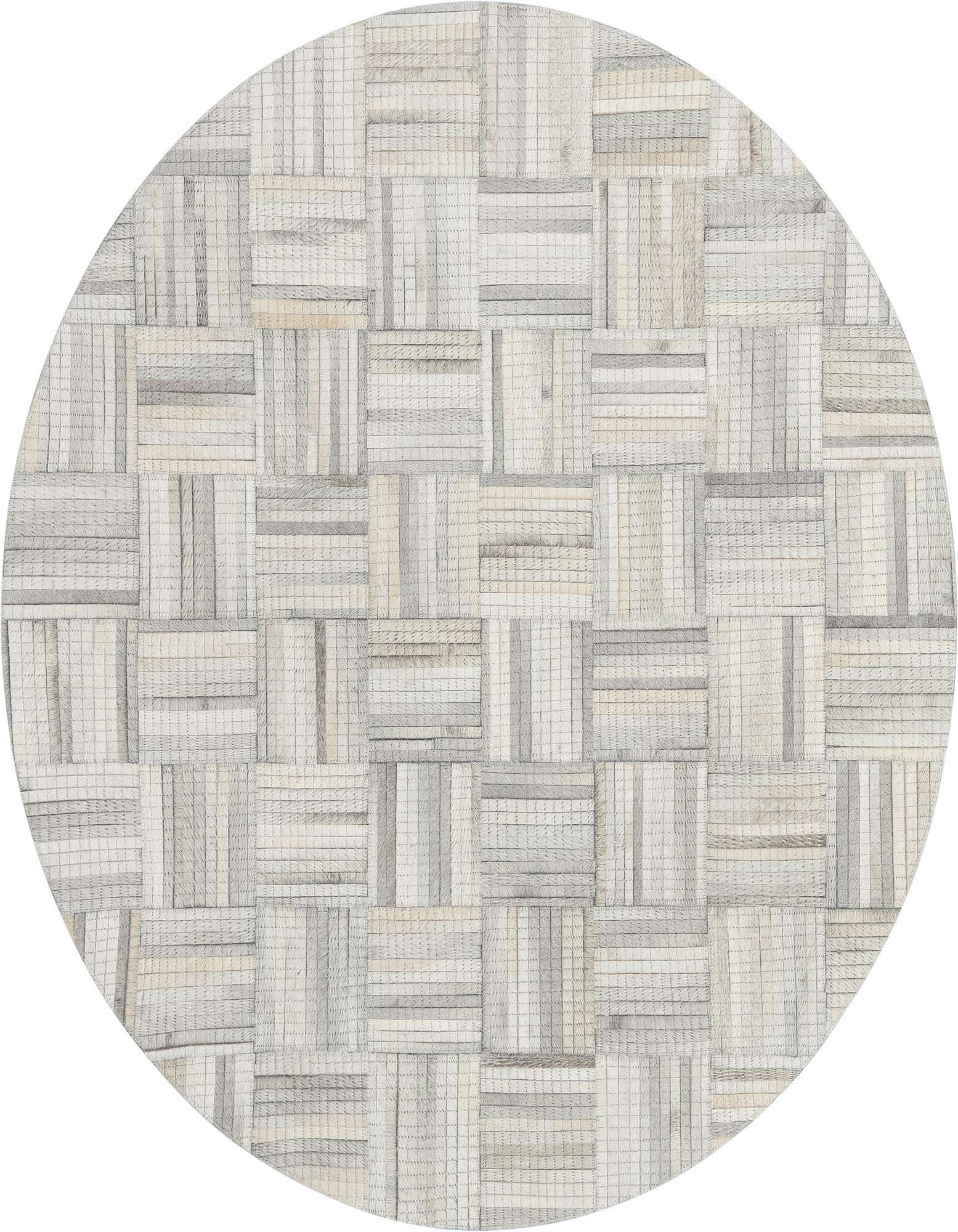 A 4' 1 round rug featuring a modern, abstract patchwork of light brown and ivory cowhide and leather squares.