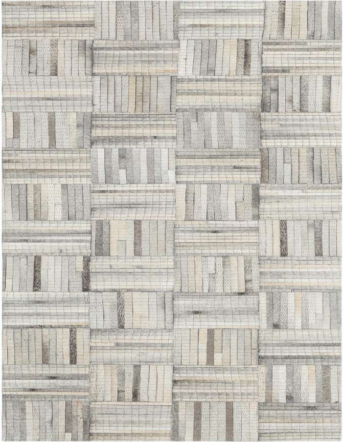 A 6 ft runner rug with a modern, abstract pattern in light brown and ivory cowhide and leather, ideal for a hallway.