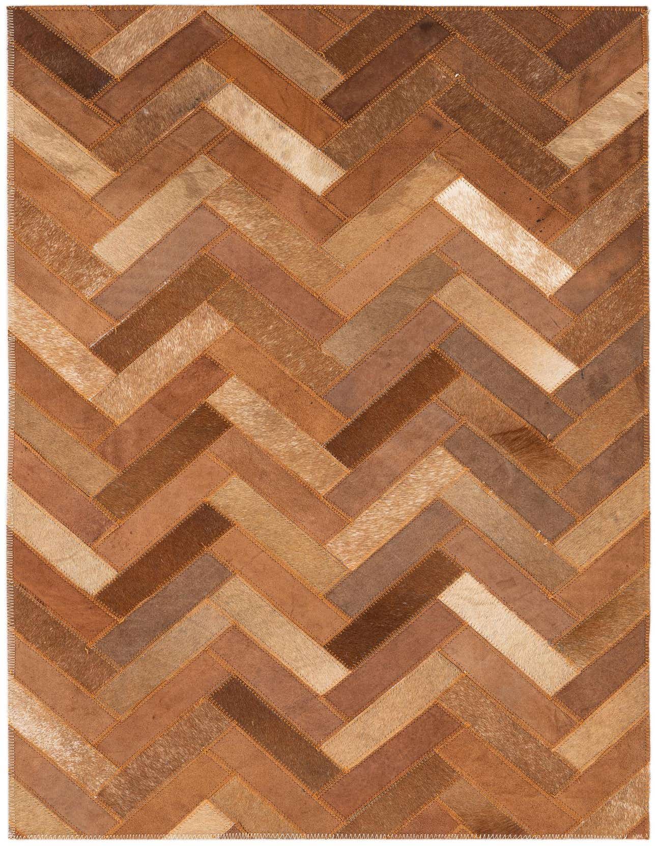 A 2x3 rectangular Cowhide Leather rug featuring a modern, abstract herringbone pattern in various shades of brown and tan.