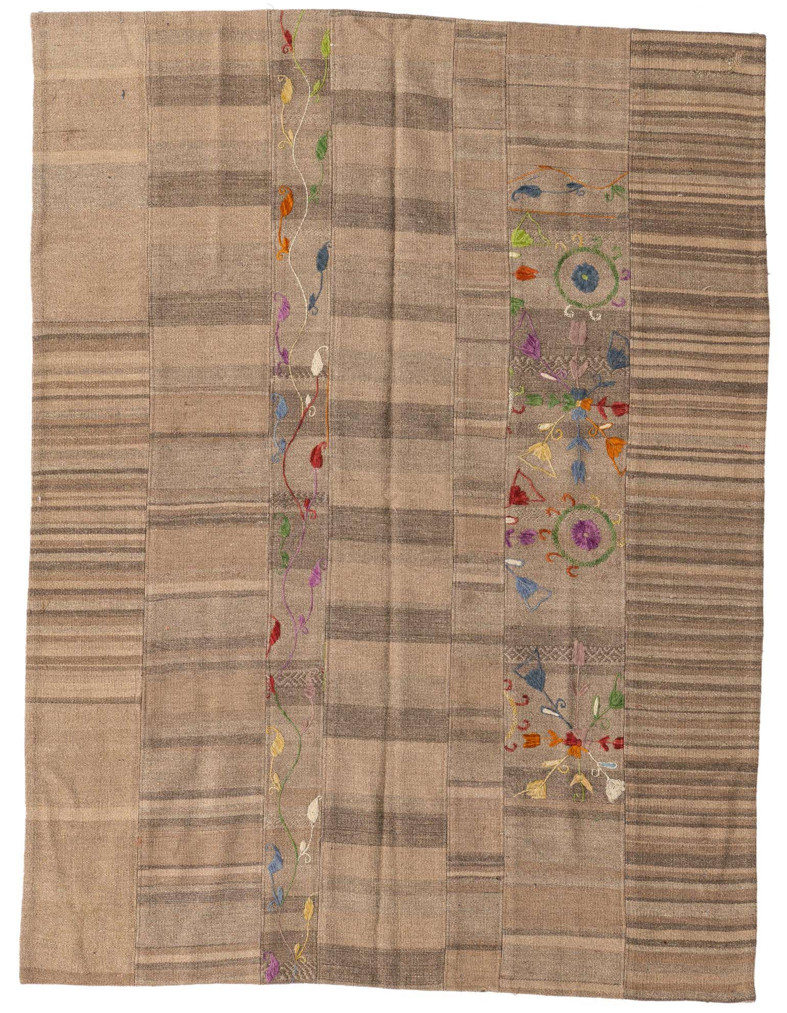 A 5x8 rectangular brown and tan wool flatweave rug with colorful tribal and floral embroidery, suitable for a living room.