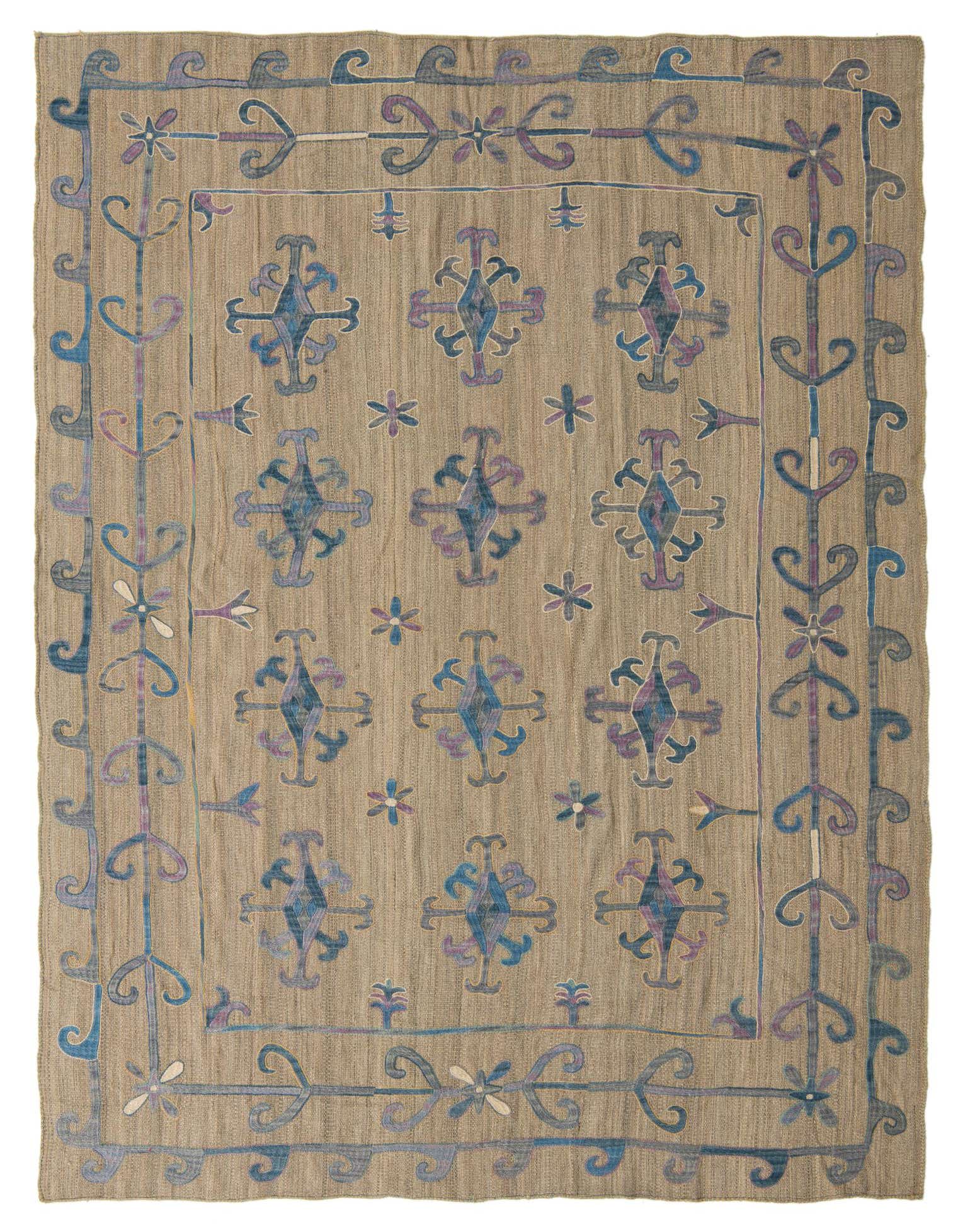 A 6x9 rectangular Kilim Suzani rug featuring a tan background with blue and purple tribal patterns and a decorative border.