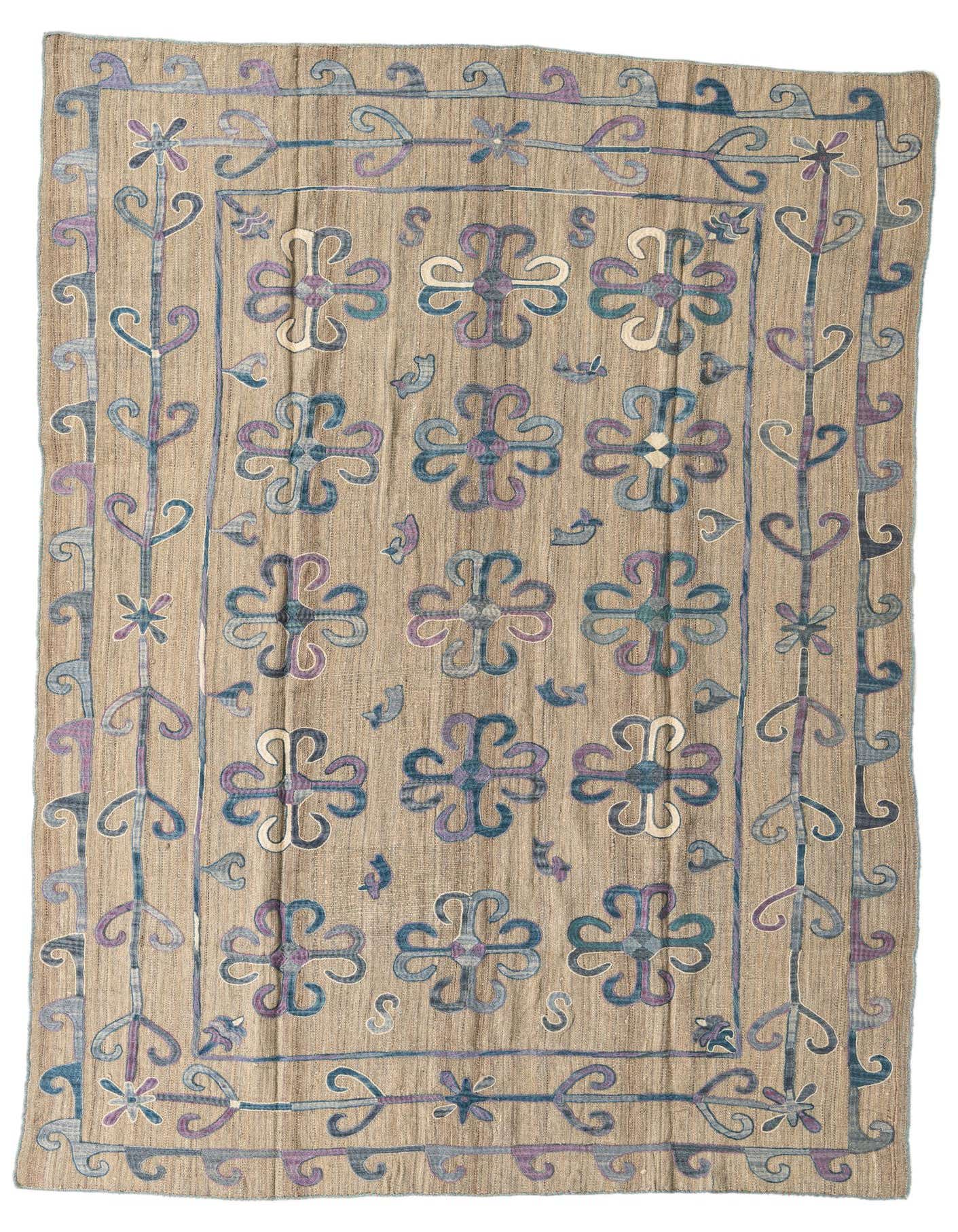 A 6x9 rectangular Kilim Suzani rug featuring a tan background with blue and purple tribal floral patterns.